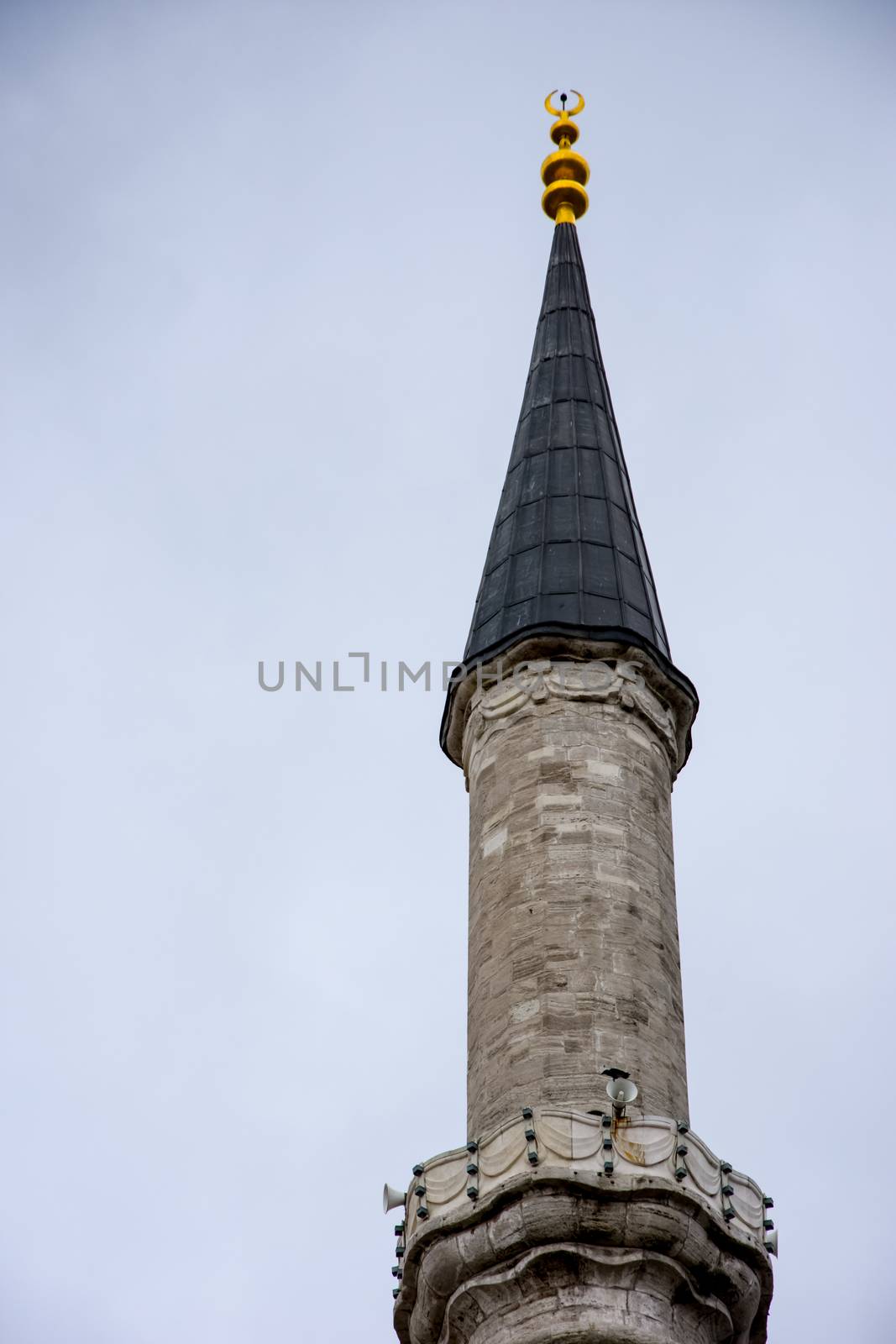 Minaret of the famous Fatih mosque built in ottoman empire in city of Istanbul