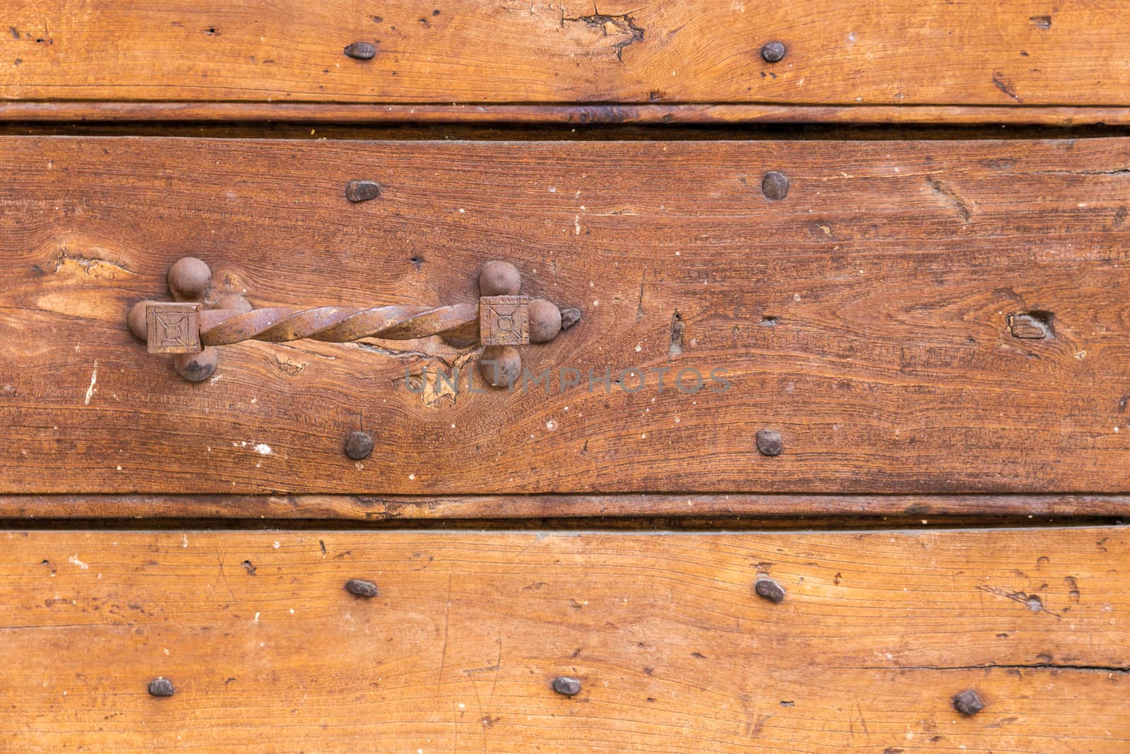 Close up of rustic old door in Spoleto, Italy.