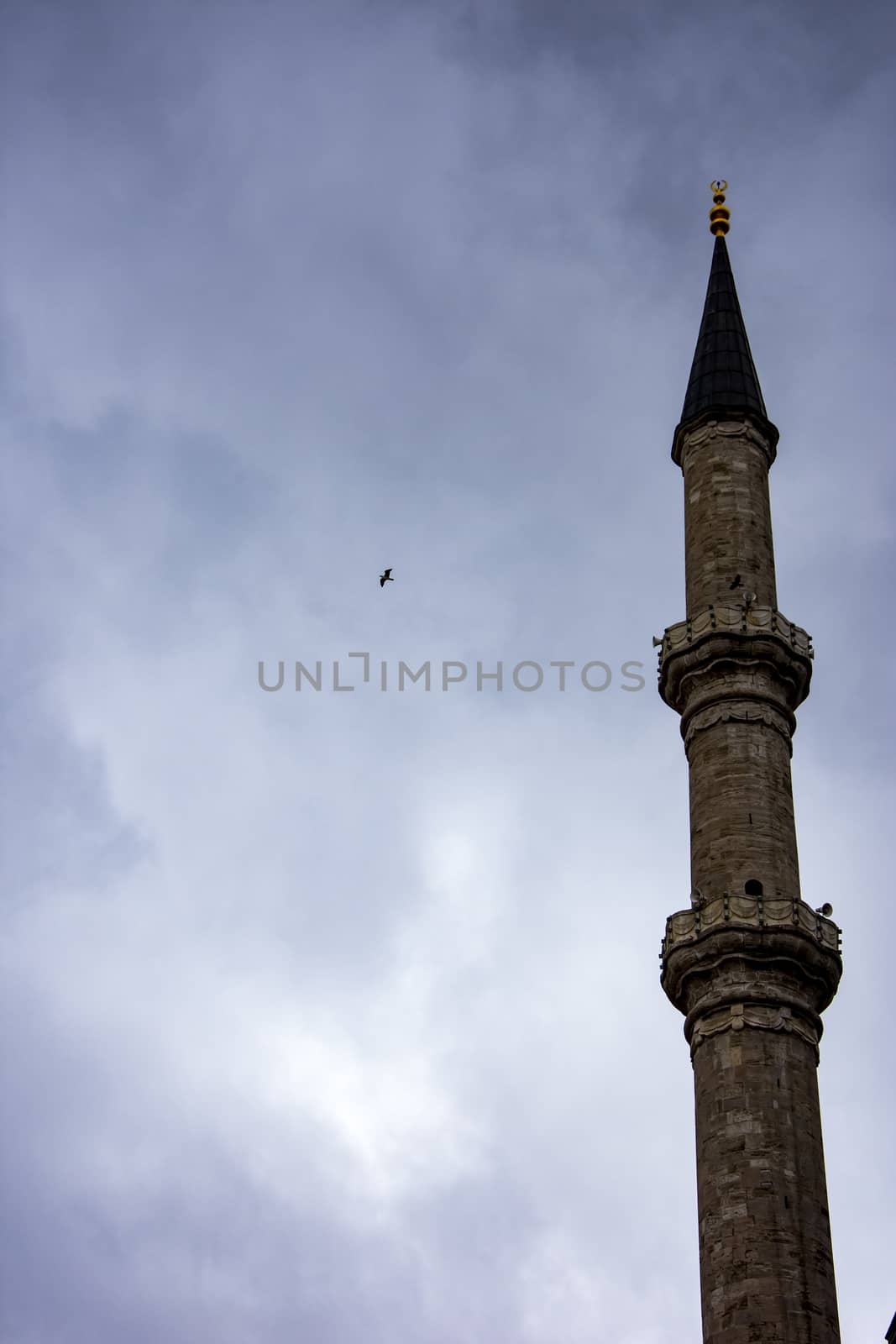 the minaret of the one famous istanbul mosque and the dark sky