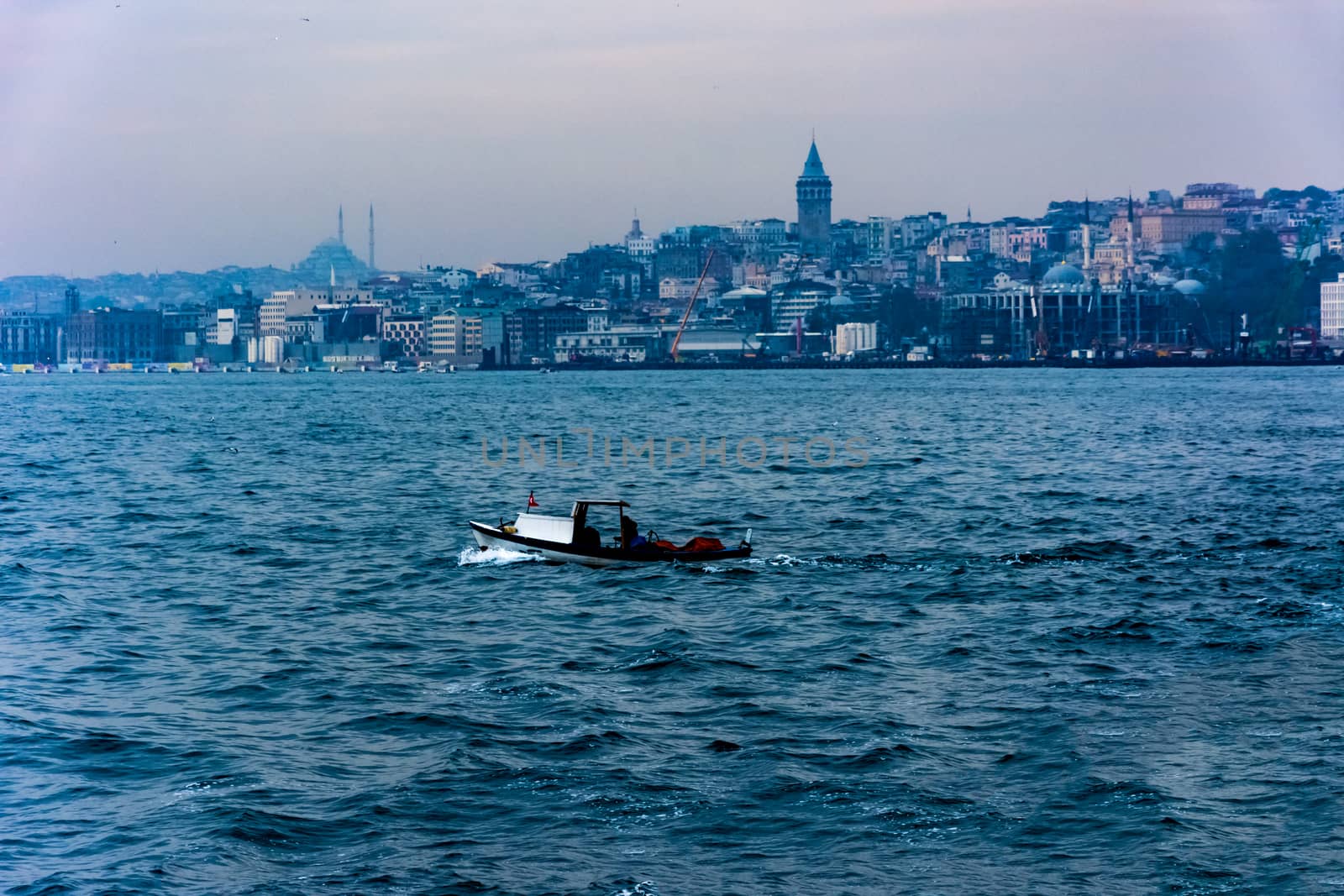 taking picture of the Galata Tower from the sea while driving on the boat