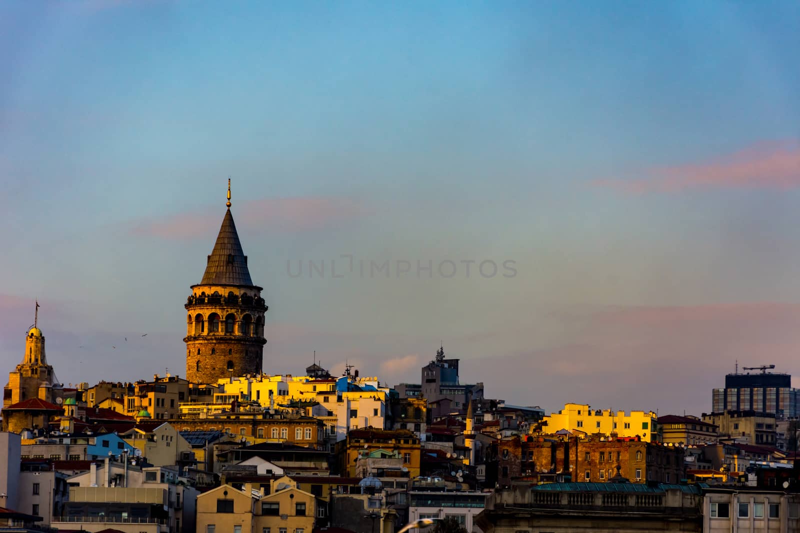 Famous Galata Tower surrounded by other buildings in the Karakoy, Istanbul