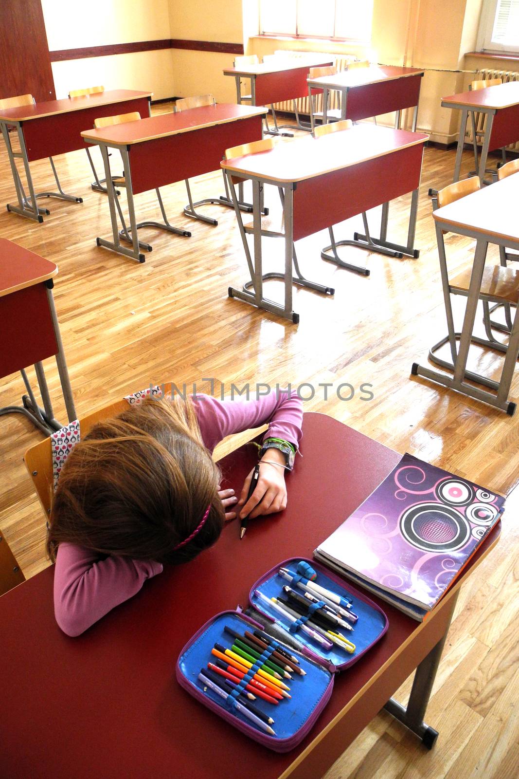 Lonely and bored student in the empty classroom