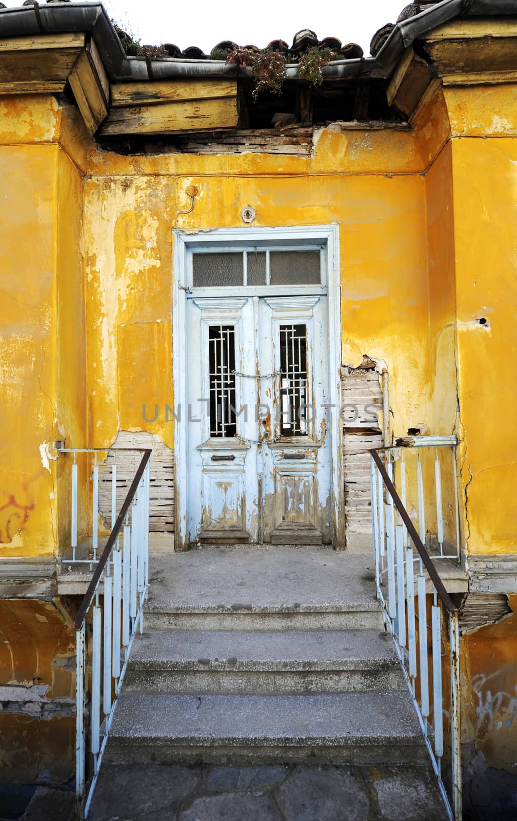 Old rustic yellow house with white door