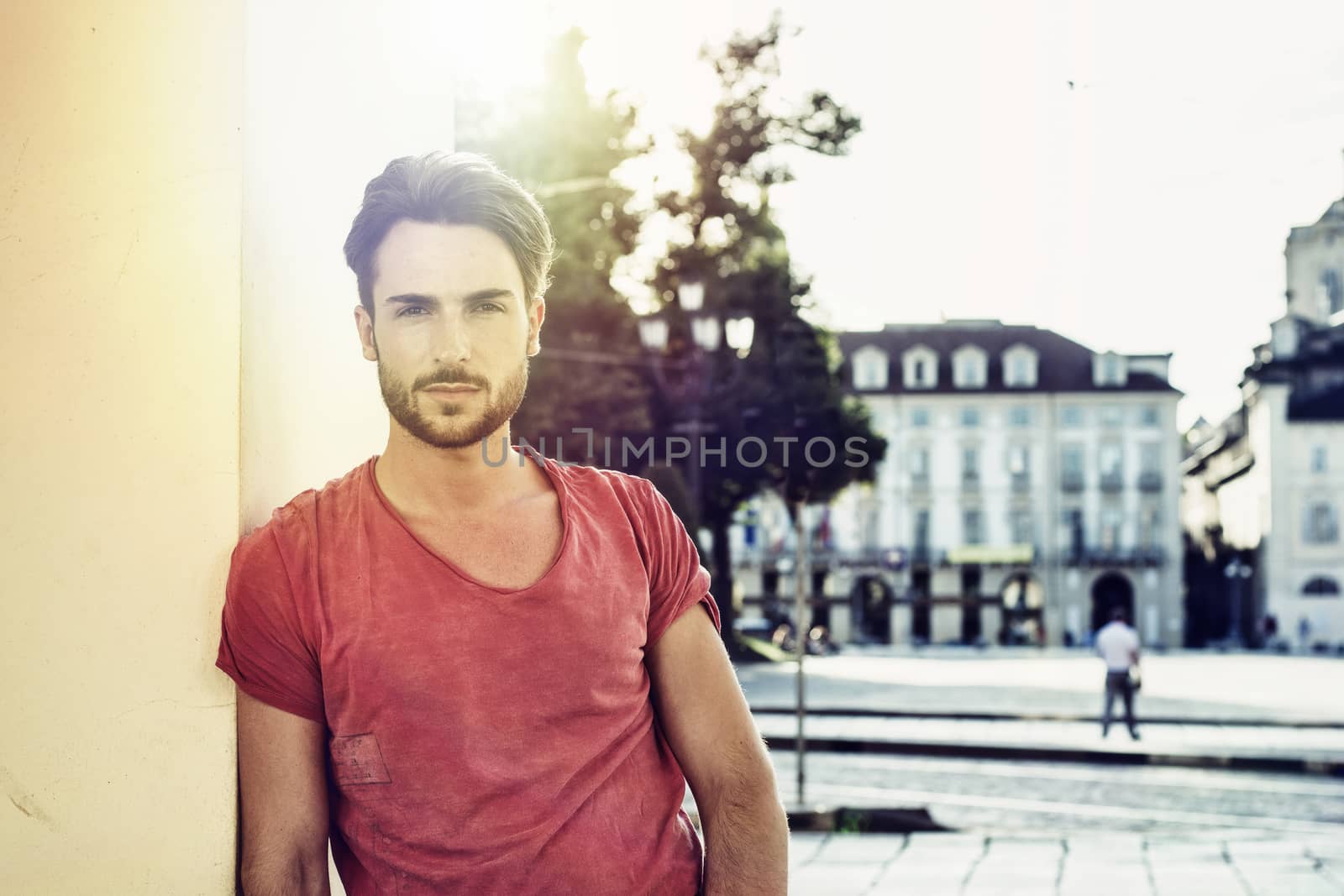 One handsome young man in urban setting in European city