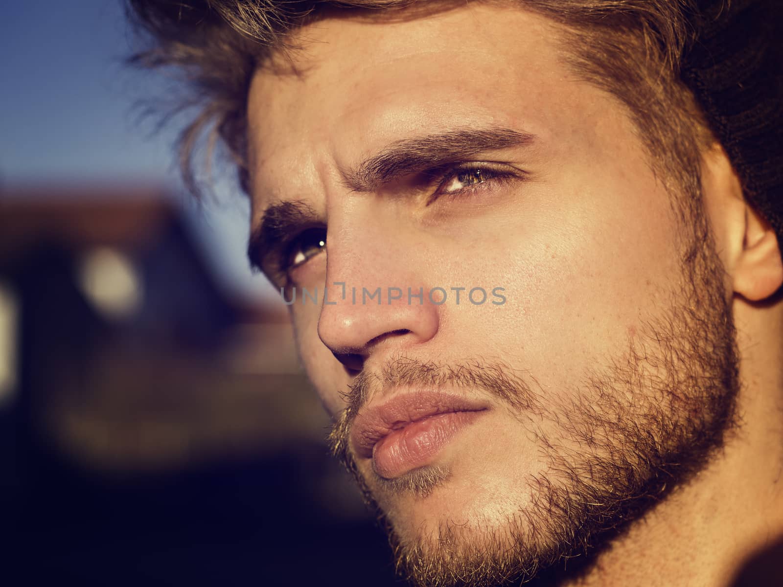 Headshot of one handsome young man in urban setting