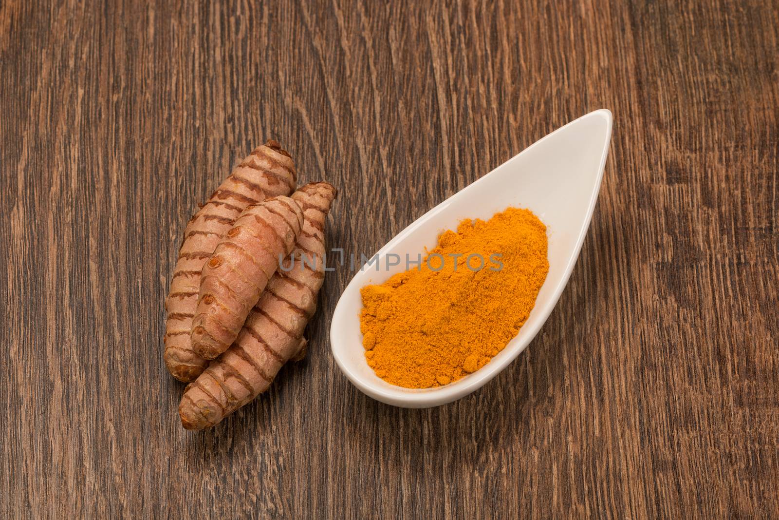 Raw and ground turmeric by ivo_13