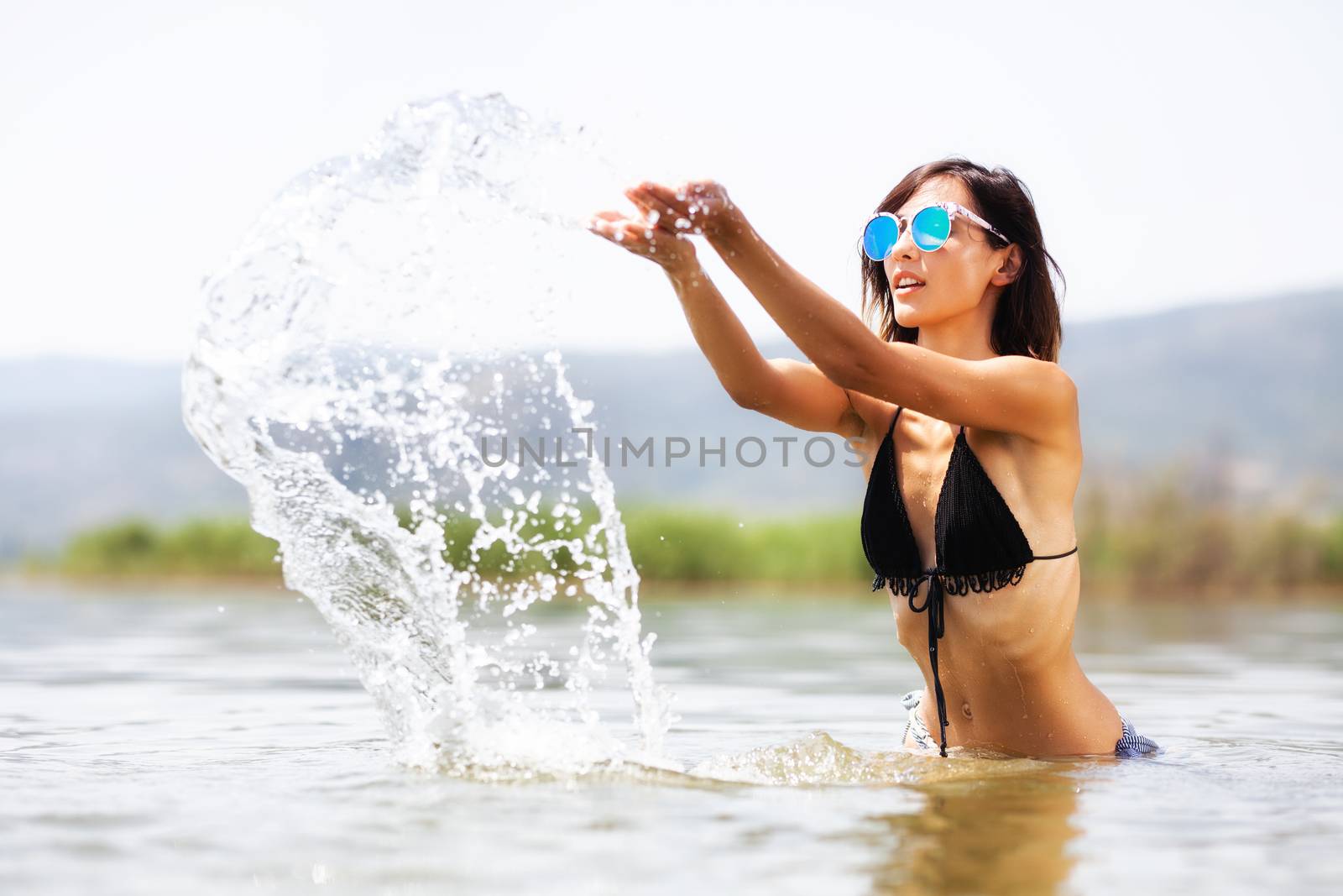 sexy girl splashing water in the air