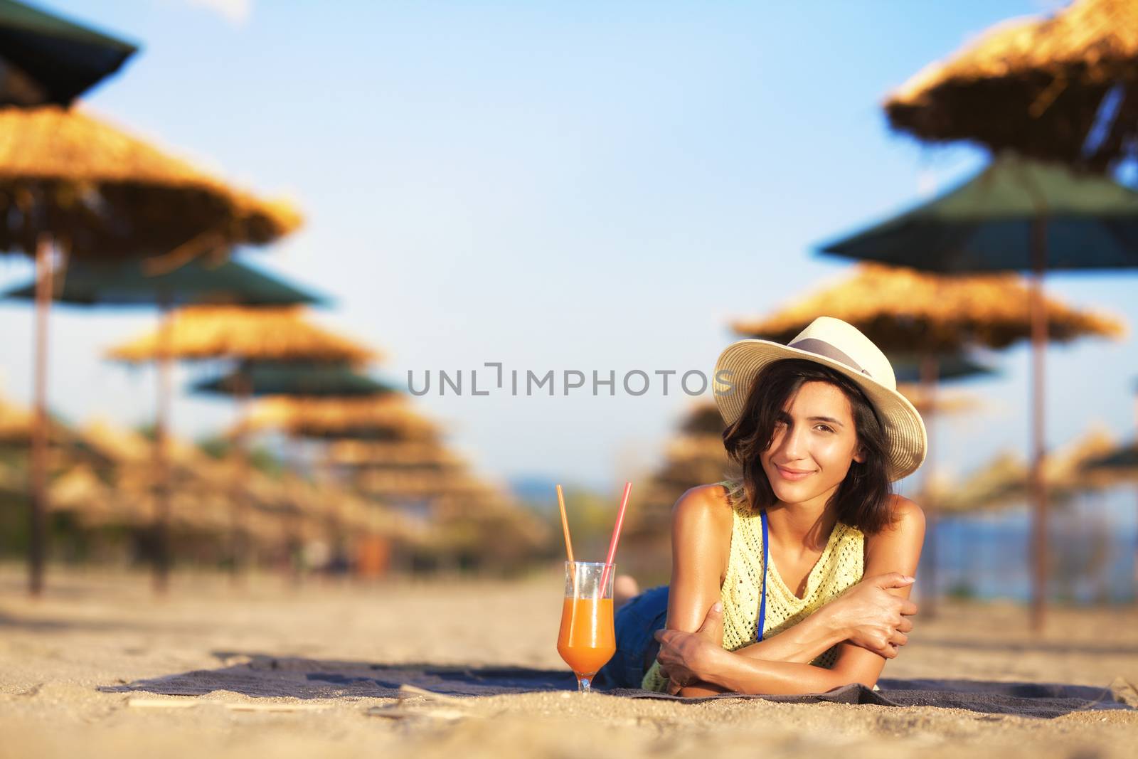beautiful girl enjoying cocktail on a beach
