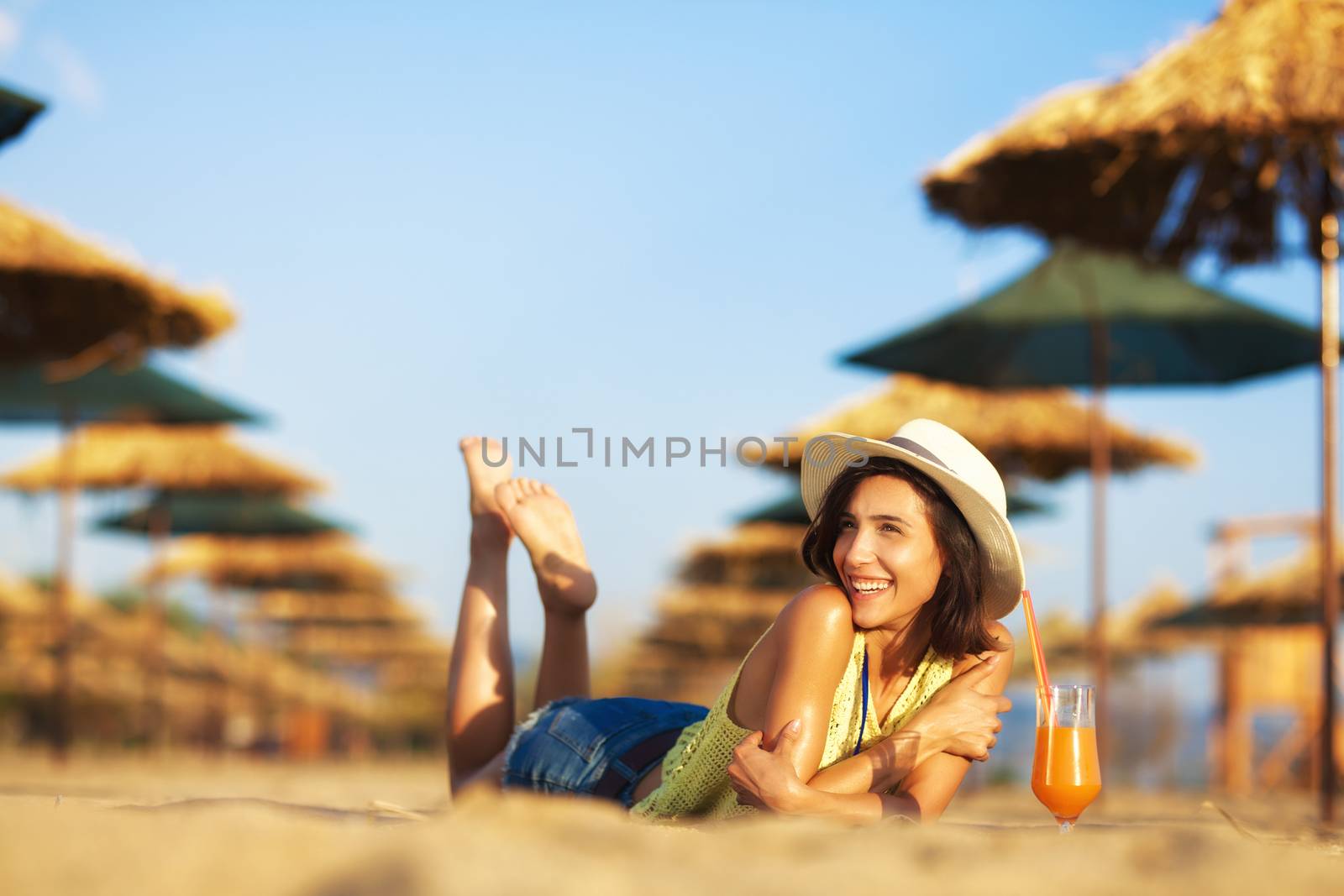 beautiful girl enjoying cocktail on a beach