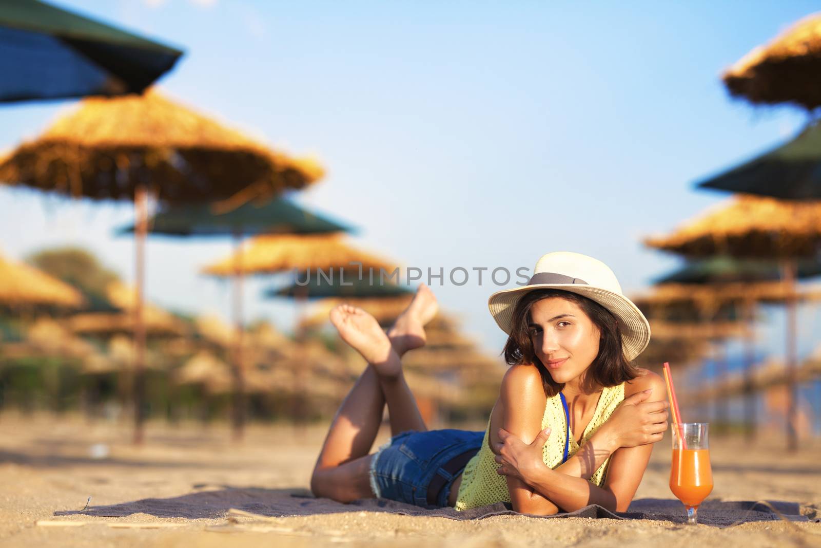 beautiful girl enjoying cocktail on a beach