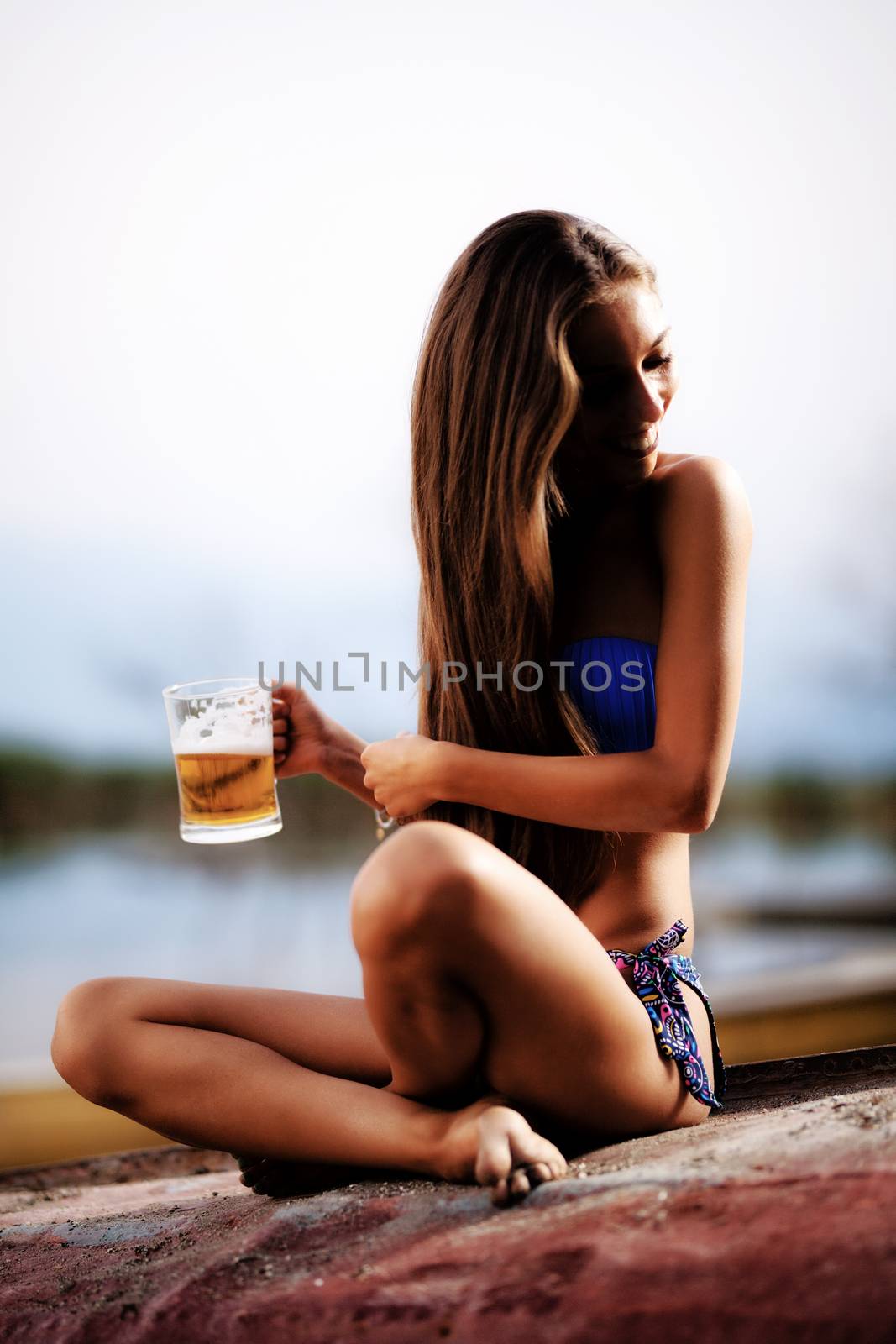 girl with beer mug on an upside down rowboat by kokimk