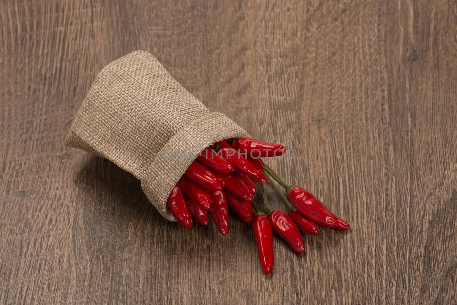 red chili peppers on dark wooden background by ivo_13