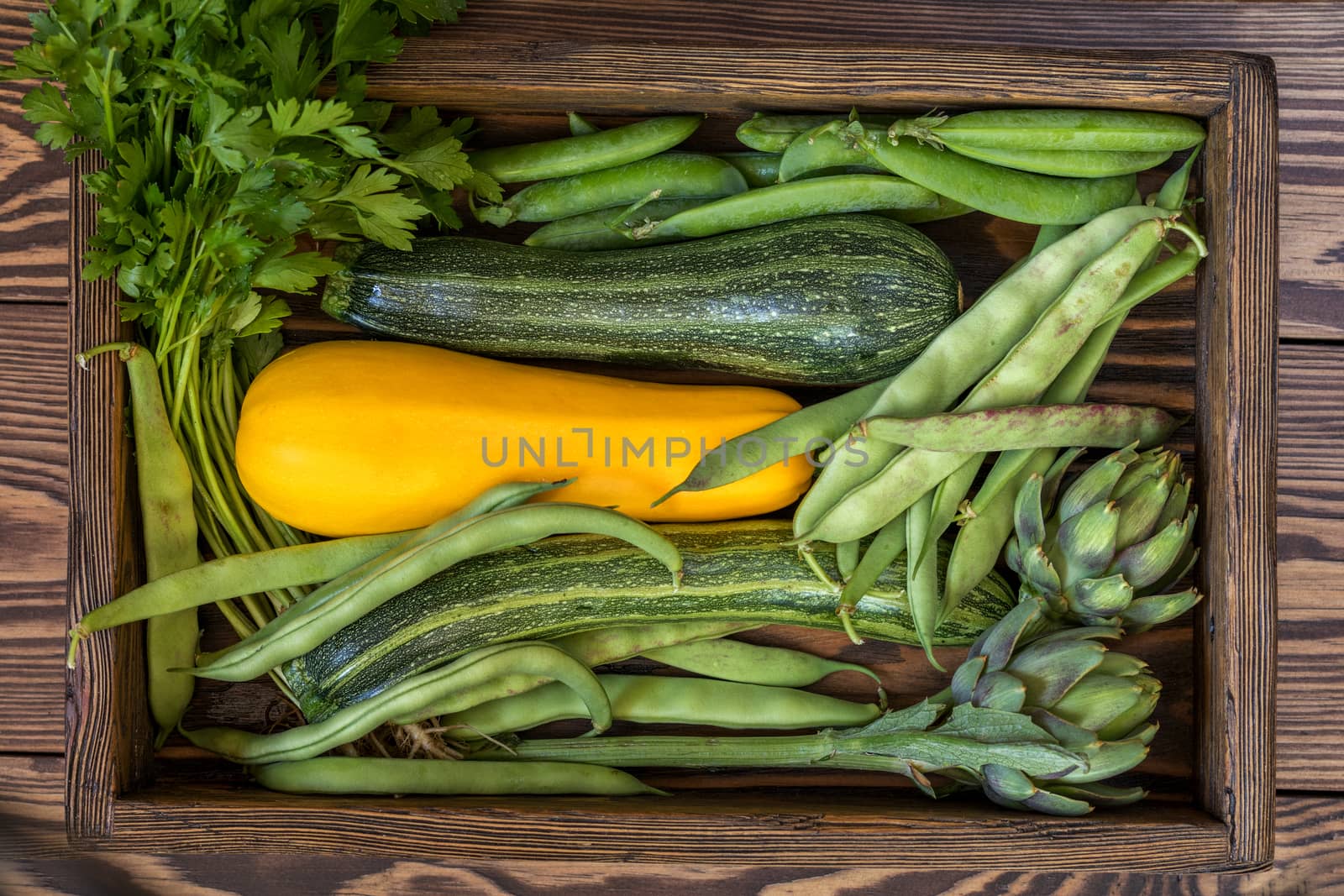 Fresh organic green vegetables wooden floor with copy space. Green and yellow vegetables background. Healthy eating background. Vegetarian food, organic food.