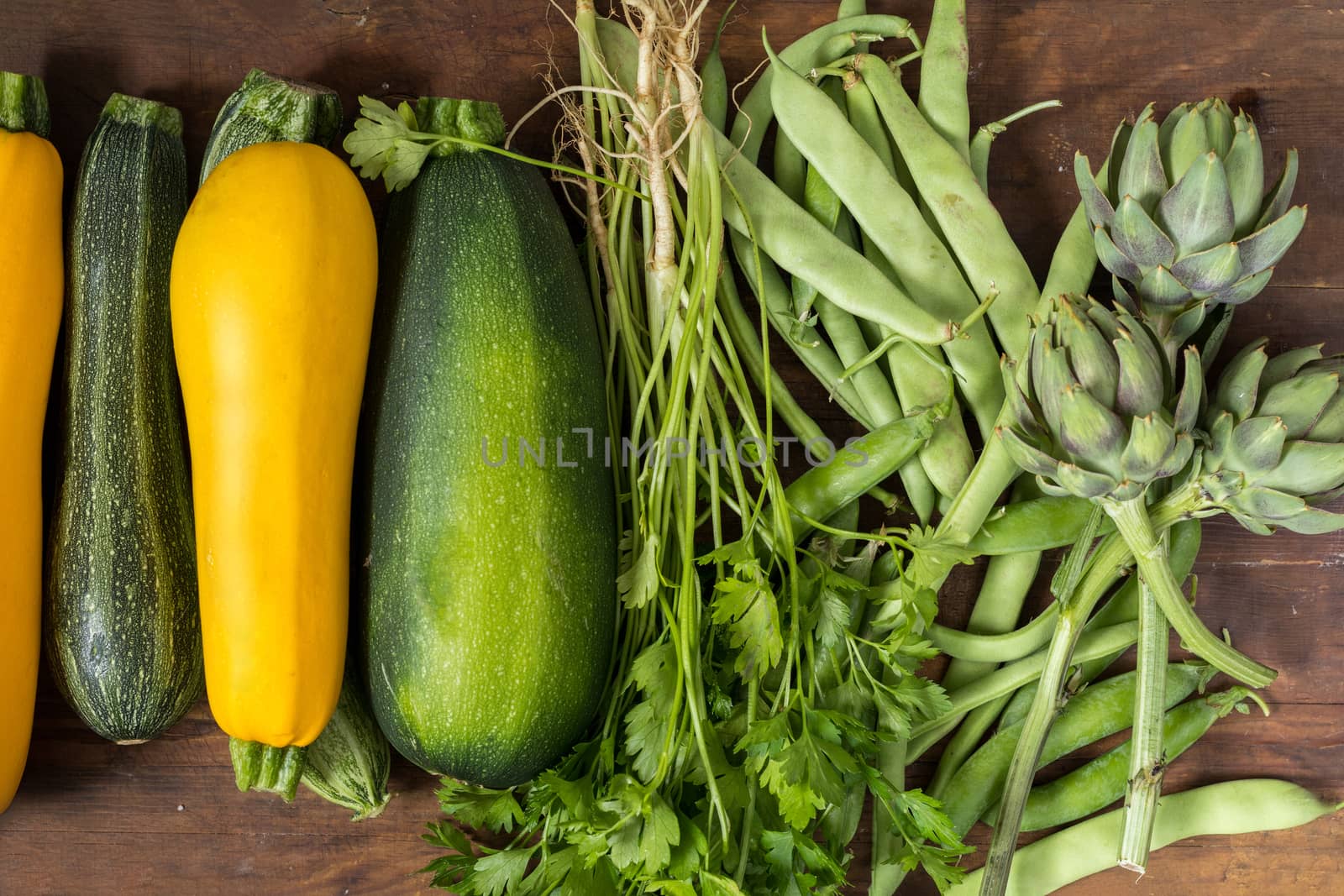Fresh organic green vegetables on wooden floor  by ArtSvitlyna