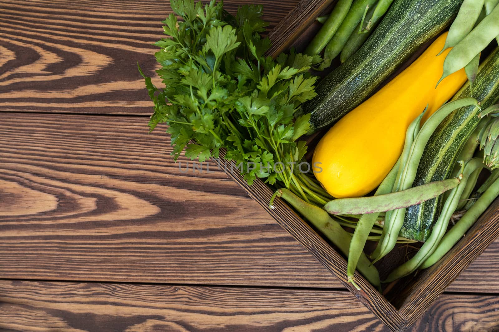 Fresh organic green vegetables wooden floor with copy space. Green and yellow vegetables background. Healthy eating background. Vegetarian food, organic food.