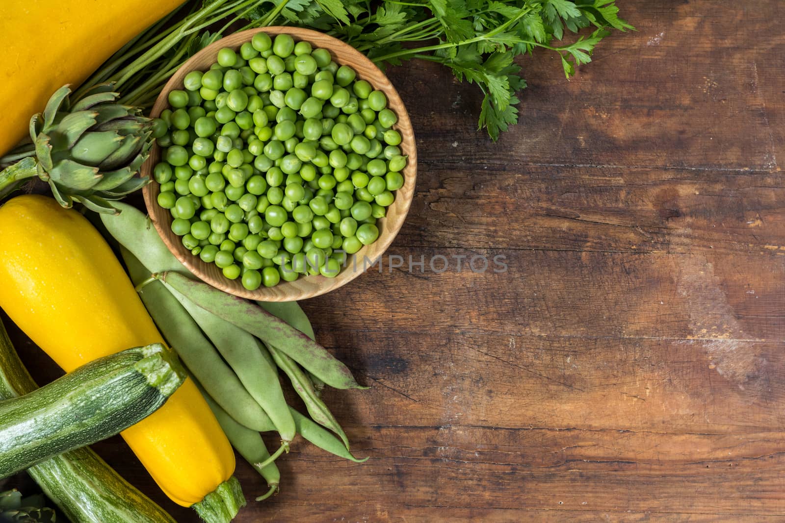 Fresh organic green vegetables on wooden floor  by ArtSvitlyna