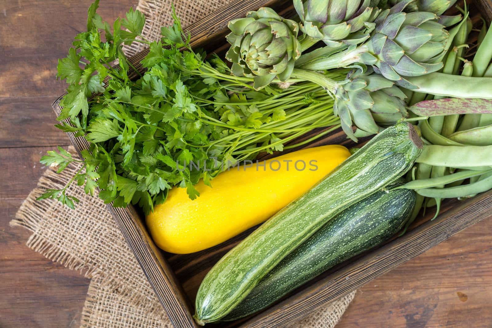 Fresh organic green vegetables on wooden floor  by ArtSvitlyna