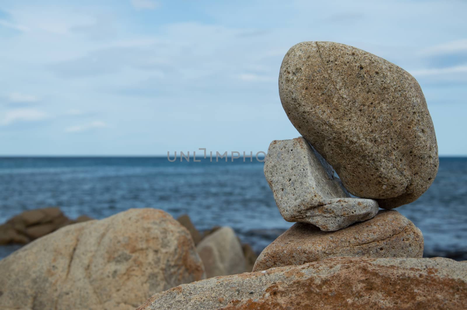 Some rocks standing in balance by the sea