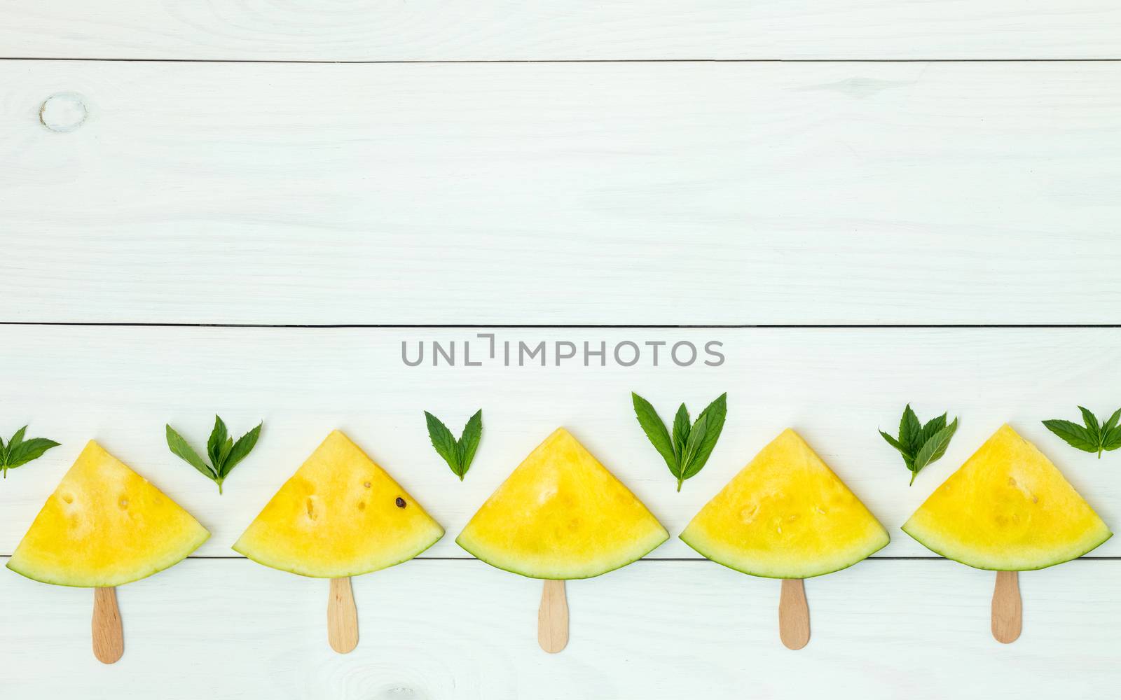 Yellow watermelon slices on sticks by ArtSvitlyna