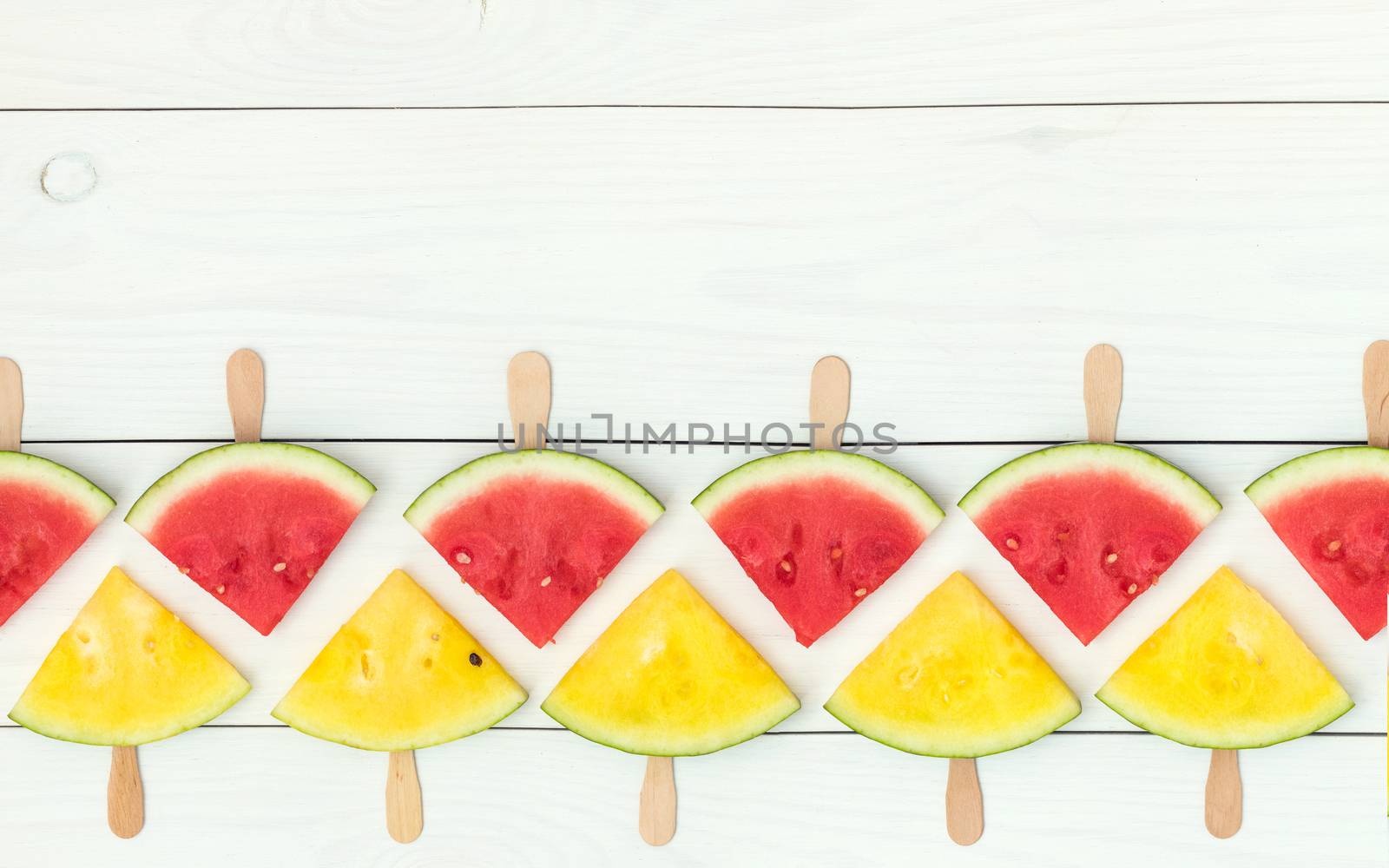 Red and yellow watermelon slices on sticks by ArtSvitlyna