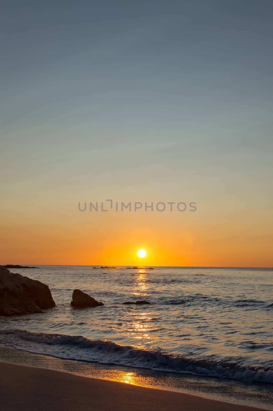 The sun rising up in Cala Ginepro in Sardinia next to Bidderosa, Italy