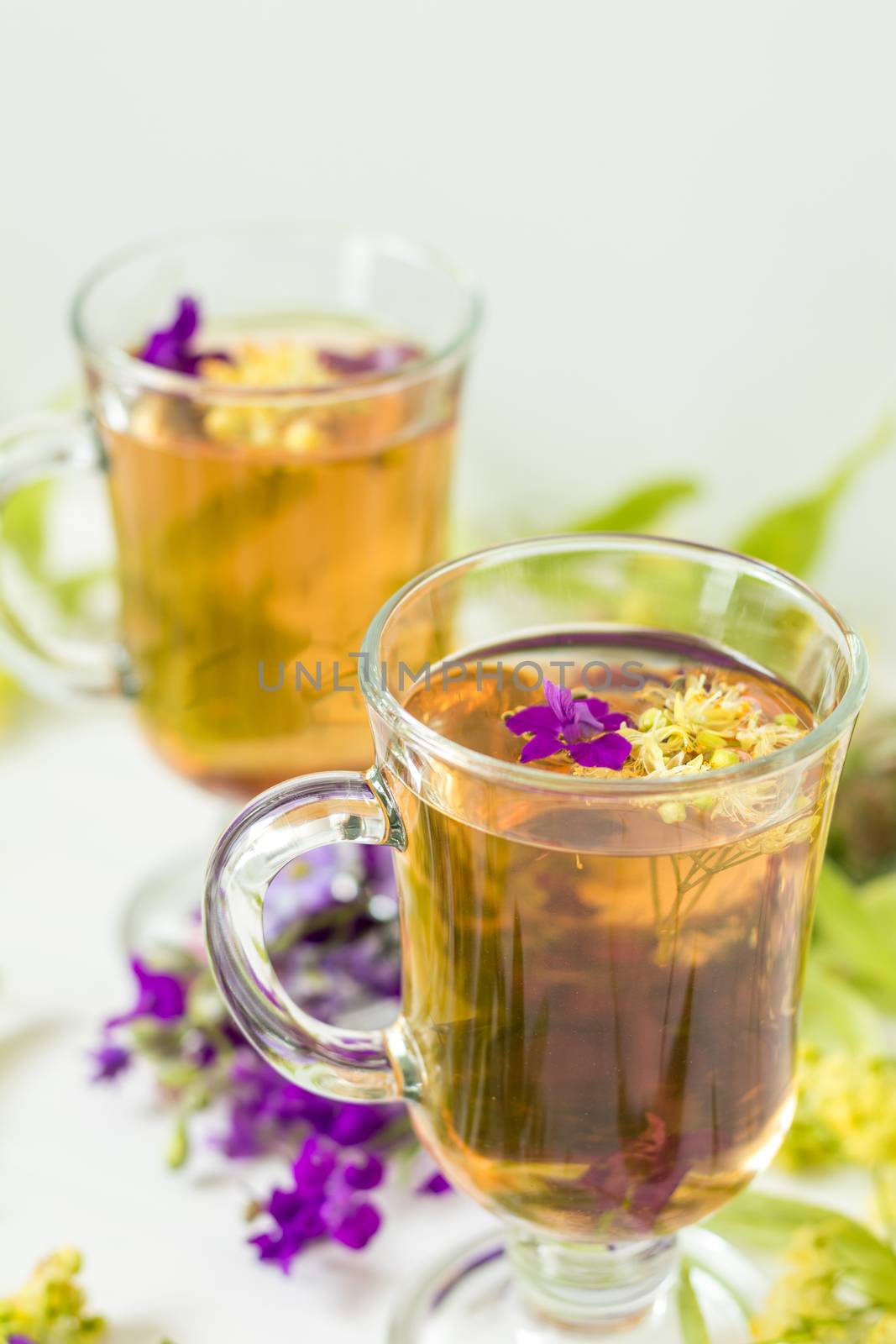 Linden herbal tea in transparent grog glass by ArtSvitlyna