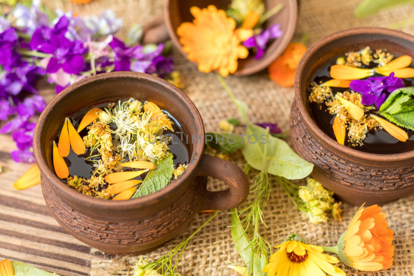 Ceramic cups of healthy herbal tea by ArtSvitlyna