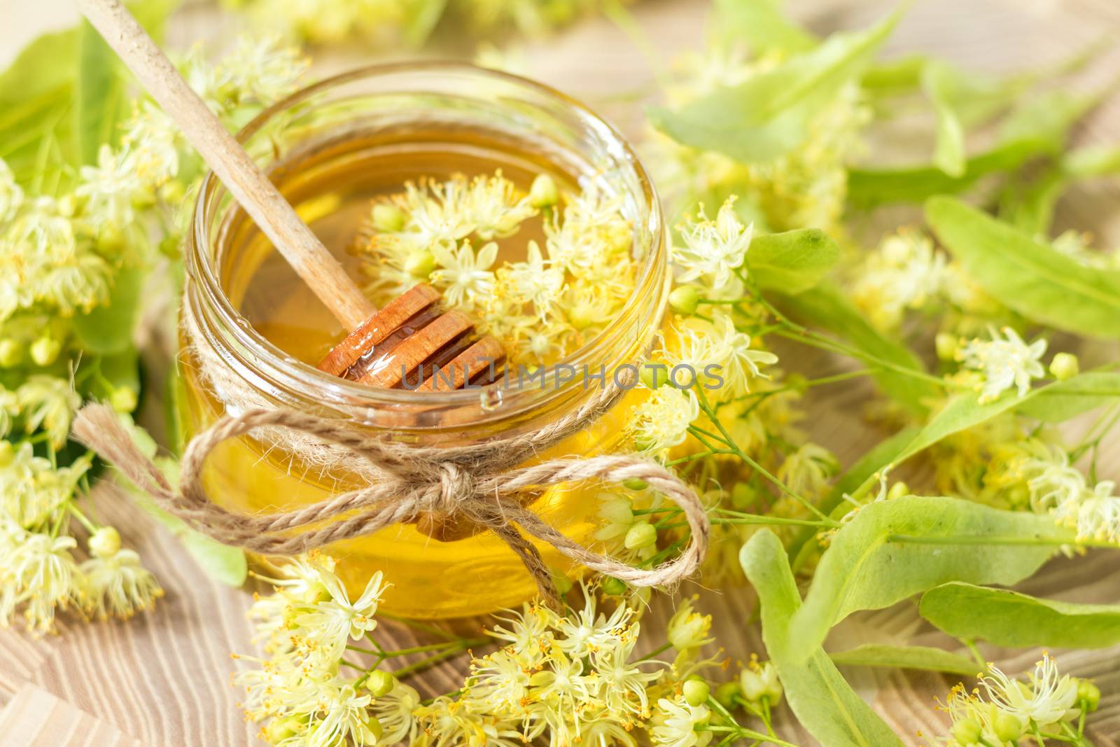 Honey in glass jars with white linden flowers by ArtSvitlyna