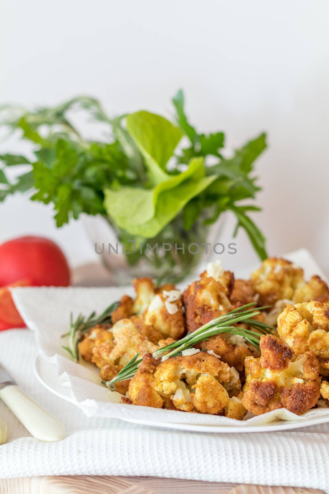 Fried cauliflower in batter on a white plate with white napkin.  by ArtSvitlyna