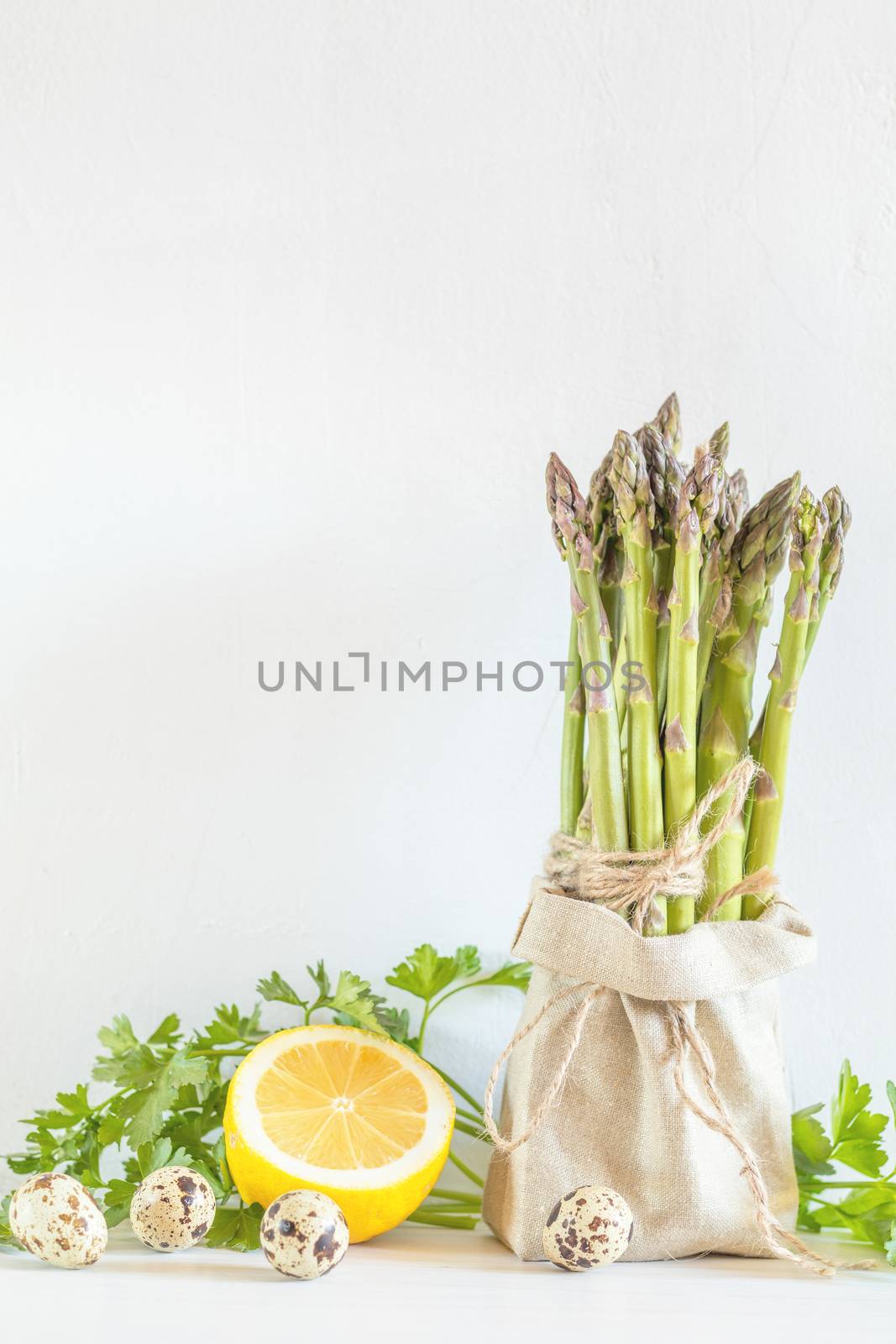 Fresh vegetables and asparagus in a little sack by ArtSvitlyna