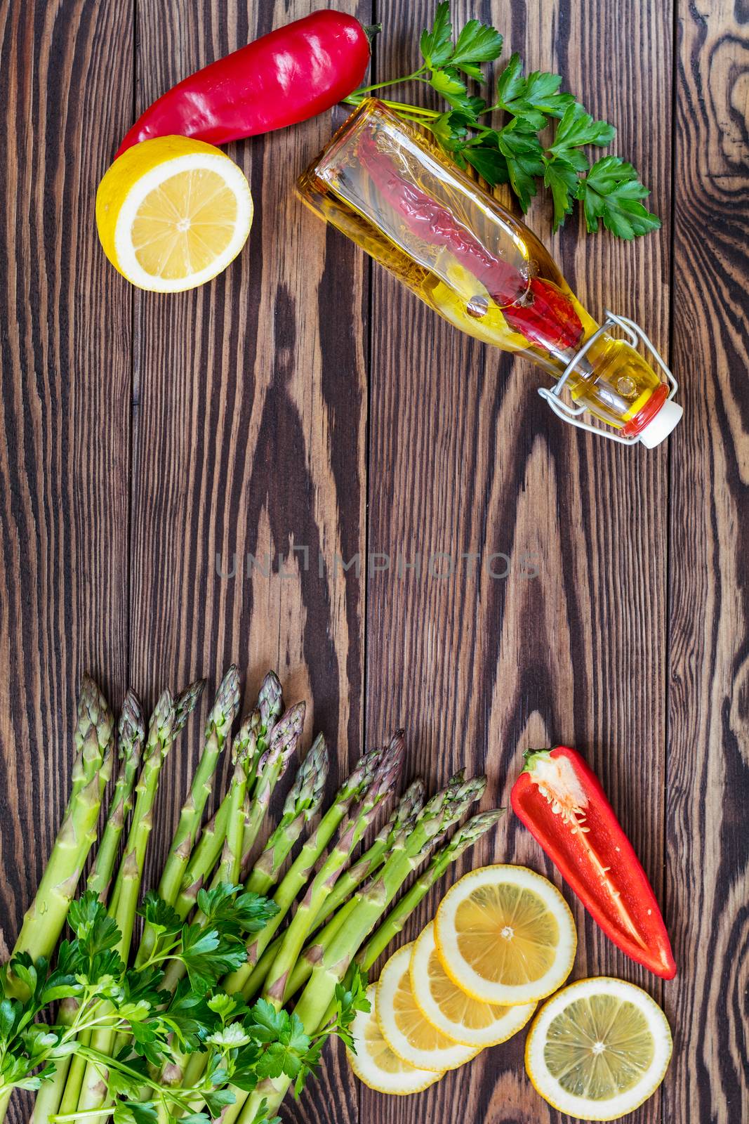 Fresh asparagus on wooden background by ArtSvitlyna