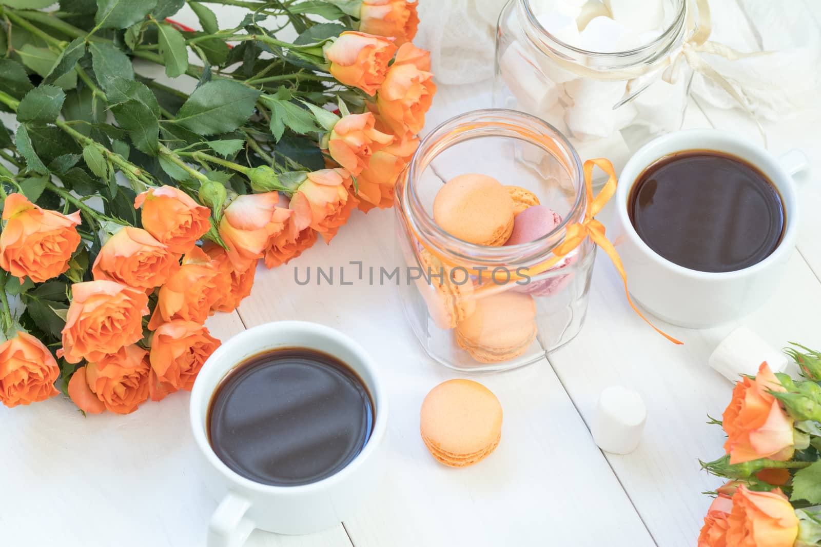 Orange macaroons, cup of coffee and fresh roses by ArtSvitlyna