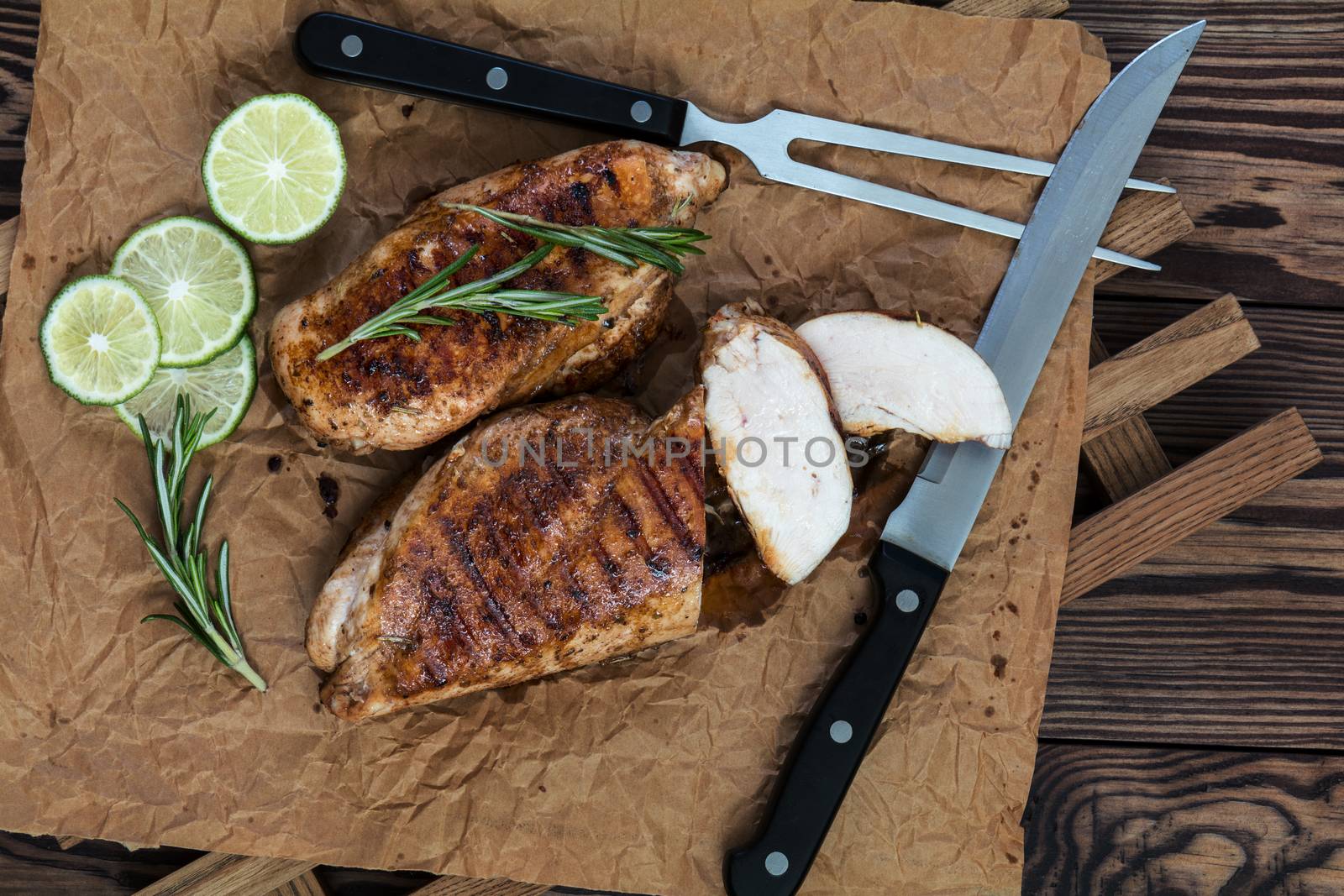 Grilled chicken filet with herbs  on a paper by ArtSvitlyna