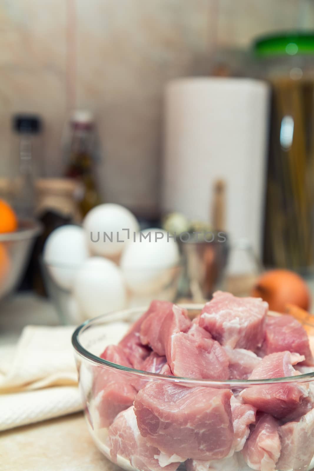 Raw pork neck meat cut in slices on glass bowl by ArtSvitlyna