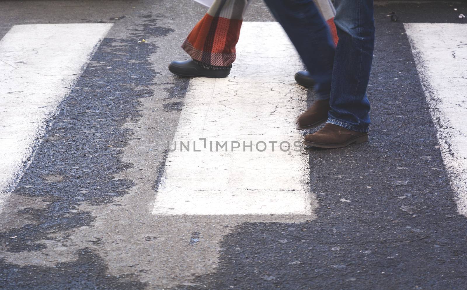 Couple walking on a zebra crossing 