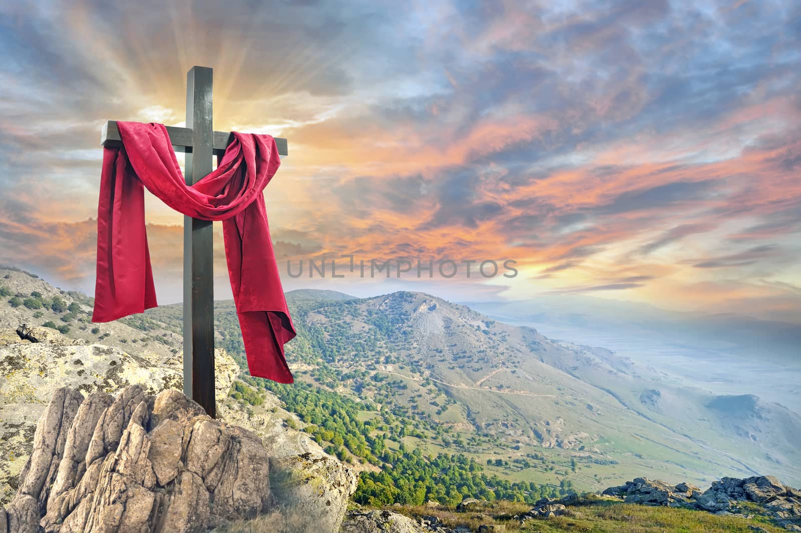 cross with red cloth against the dramatic sky