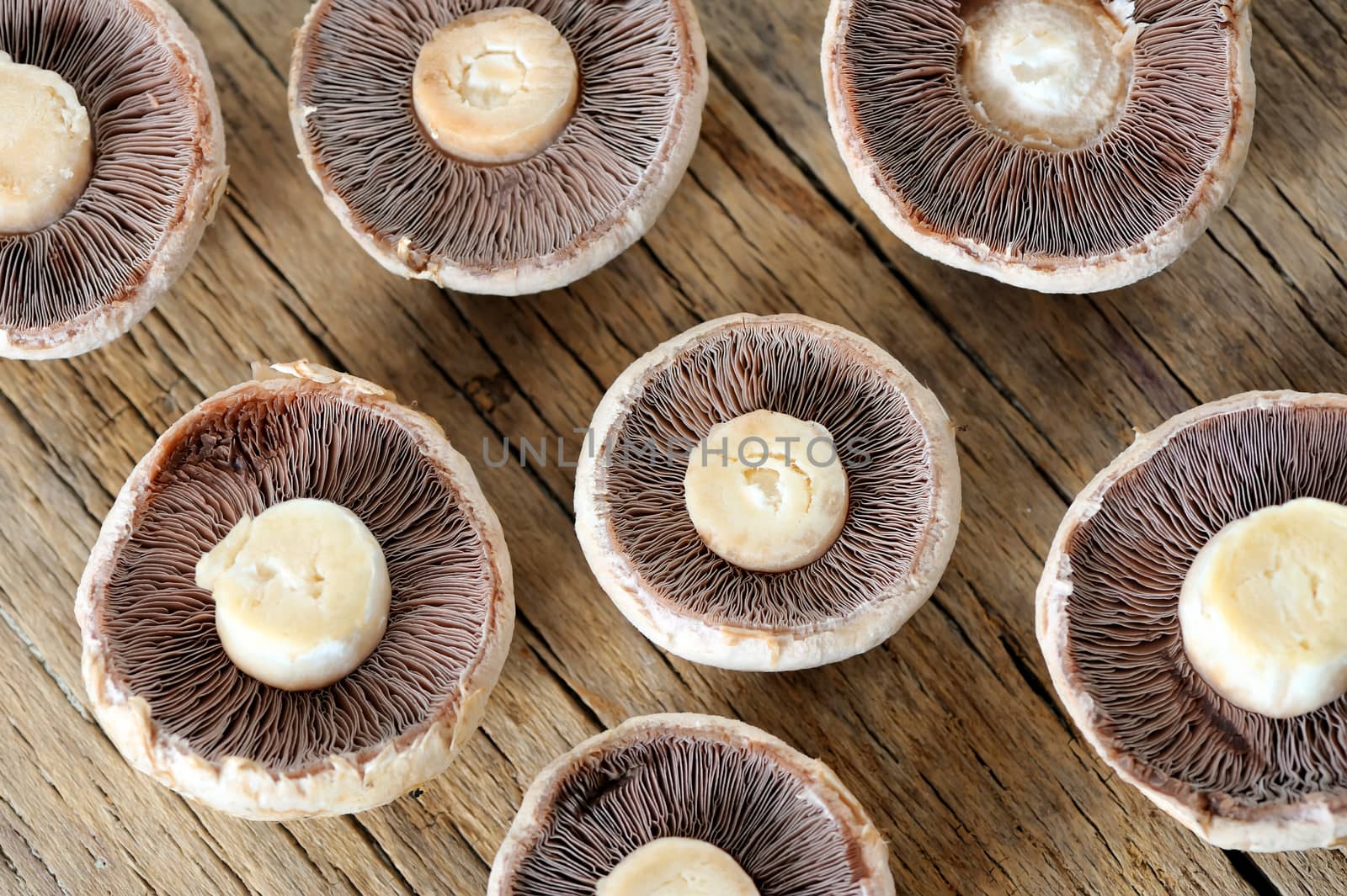 Sliced mushrooms on old wooden table