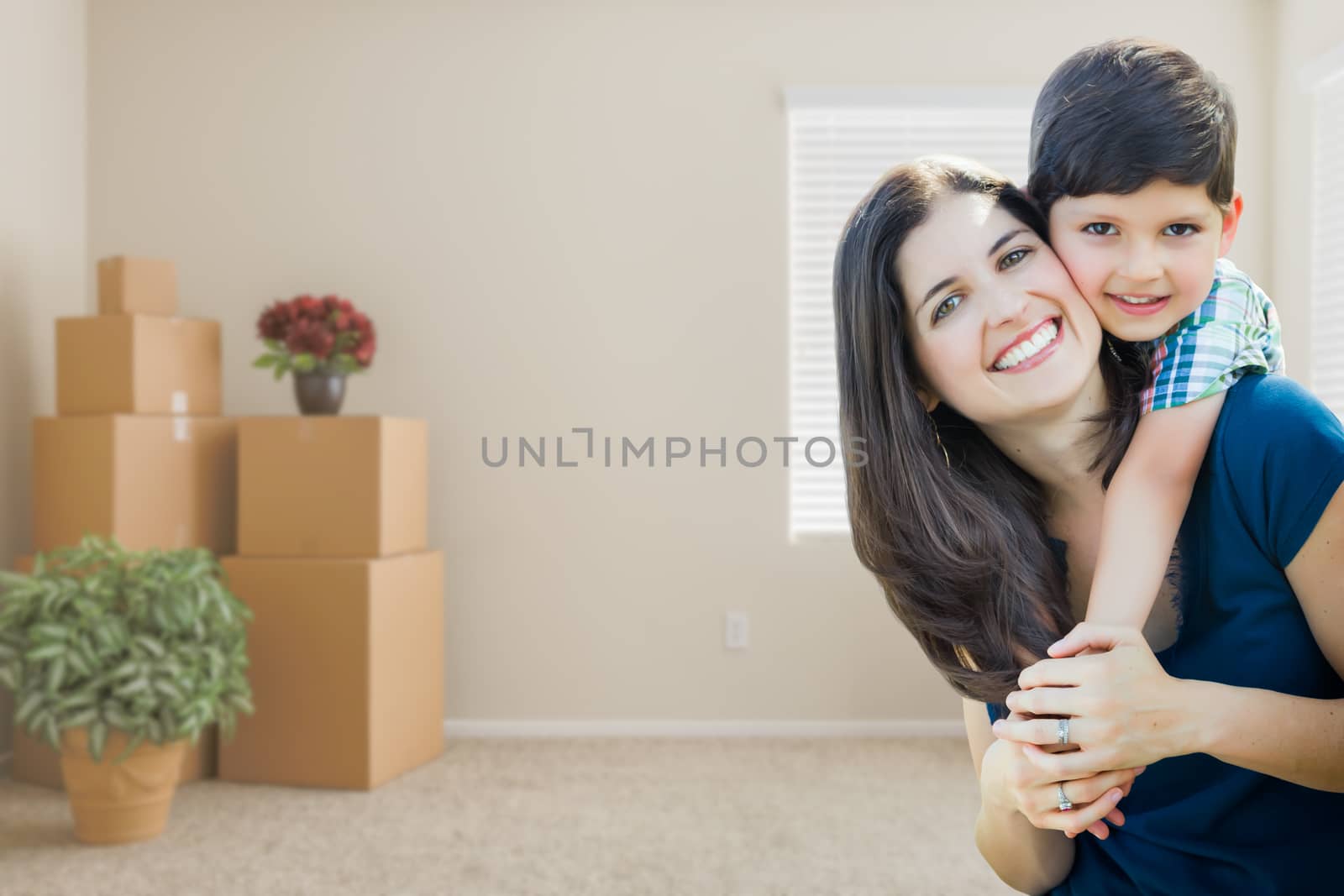 Young Mother and Son Inside Empty Room with Moving Boxes. by Feverpitched
