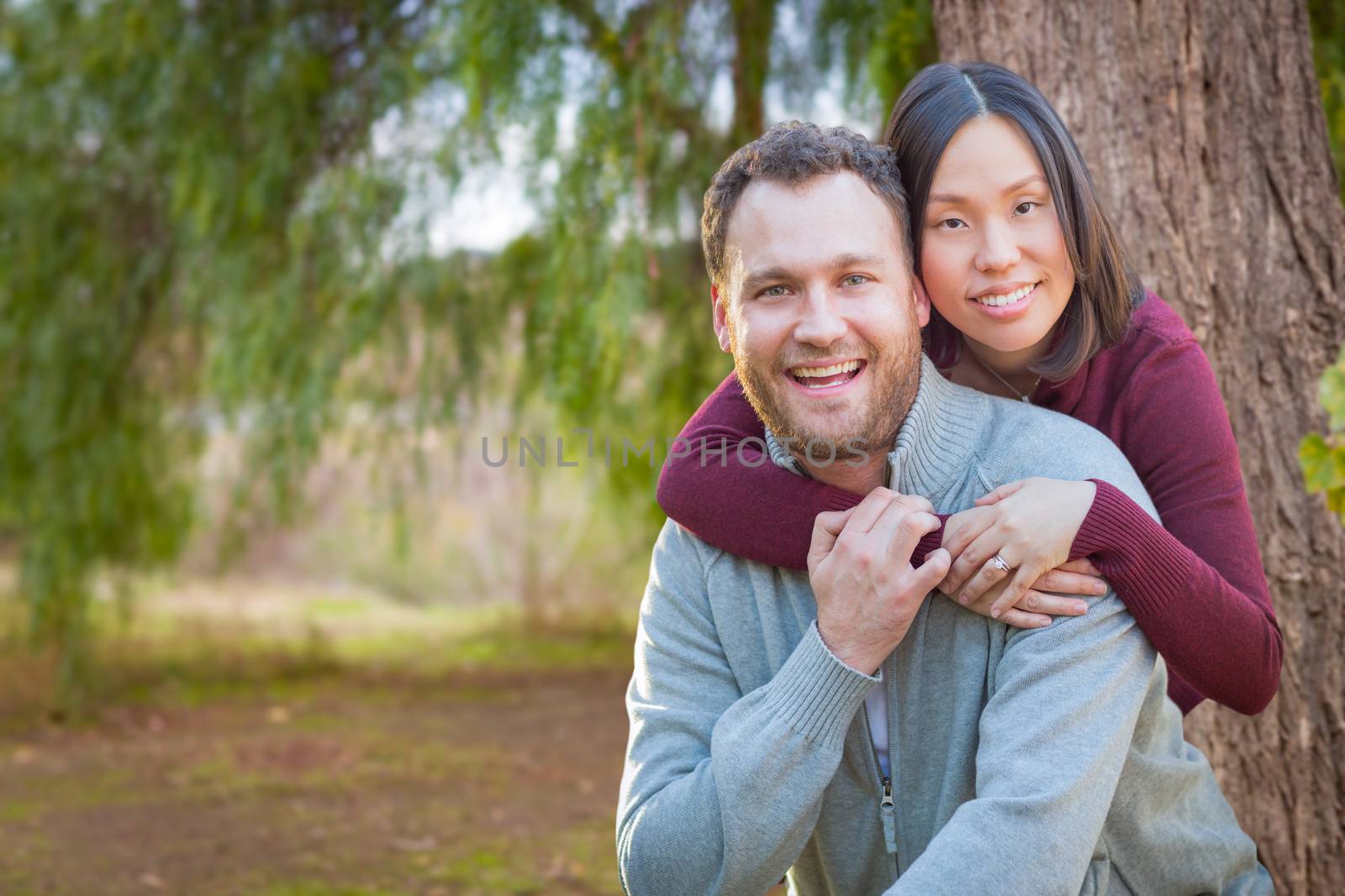 Mixed Race Caucasian and Chinese Couple Portrait Outdoors. by Feverpitched