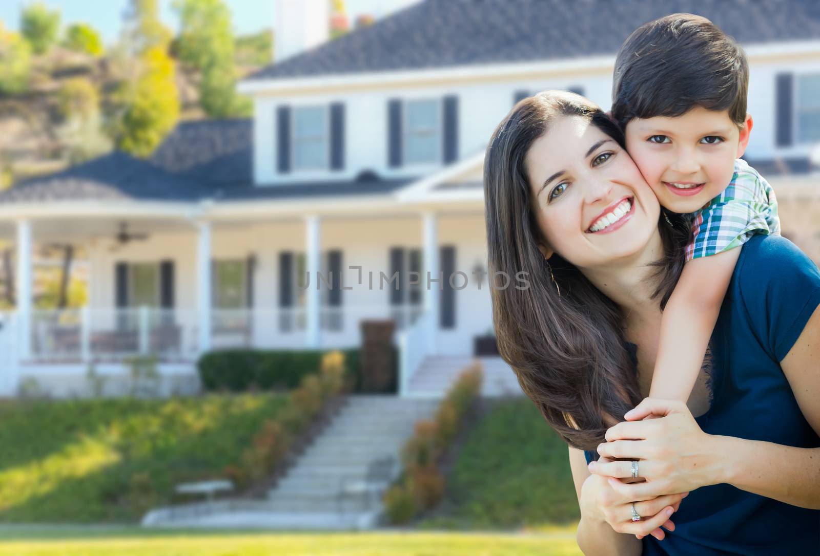 Young Mother and Son In Front Yard of Beautiful Custom House. by Feverpitched
