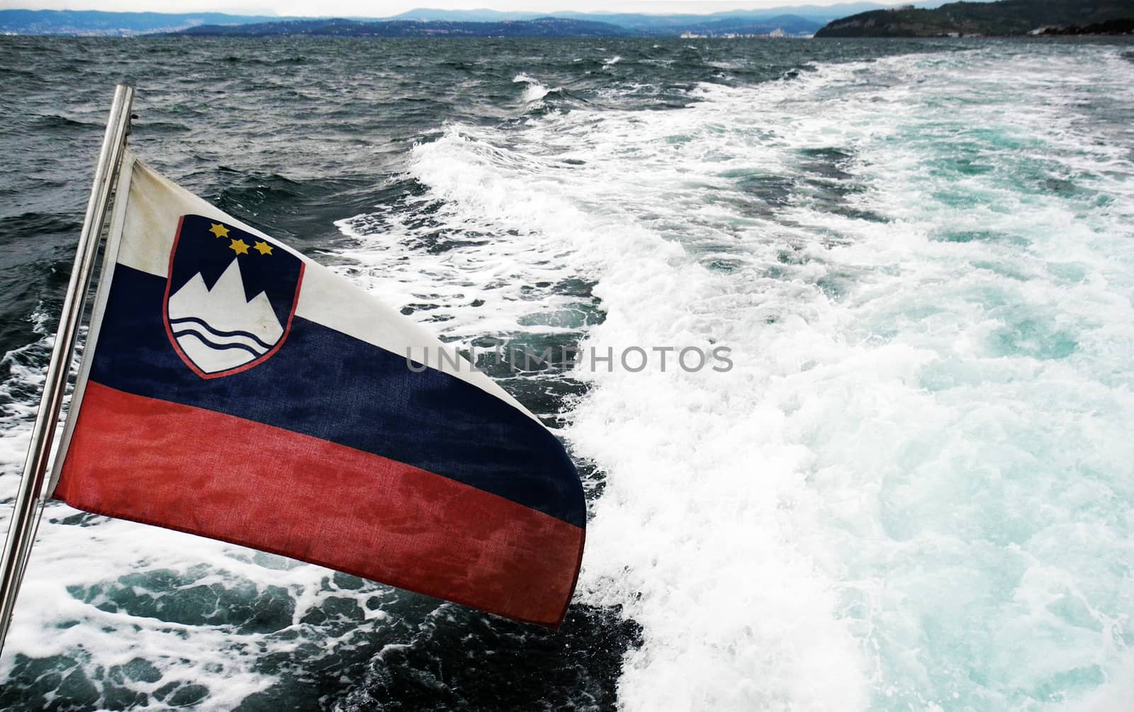 Slovenian flag on fast the boat at sea