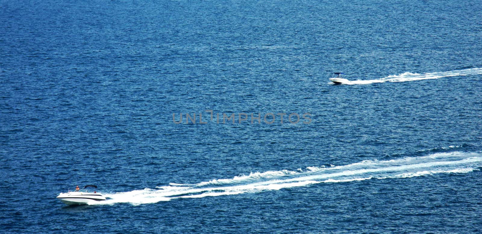 Far distance view on two speedboats on summer day