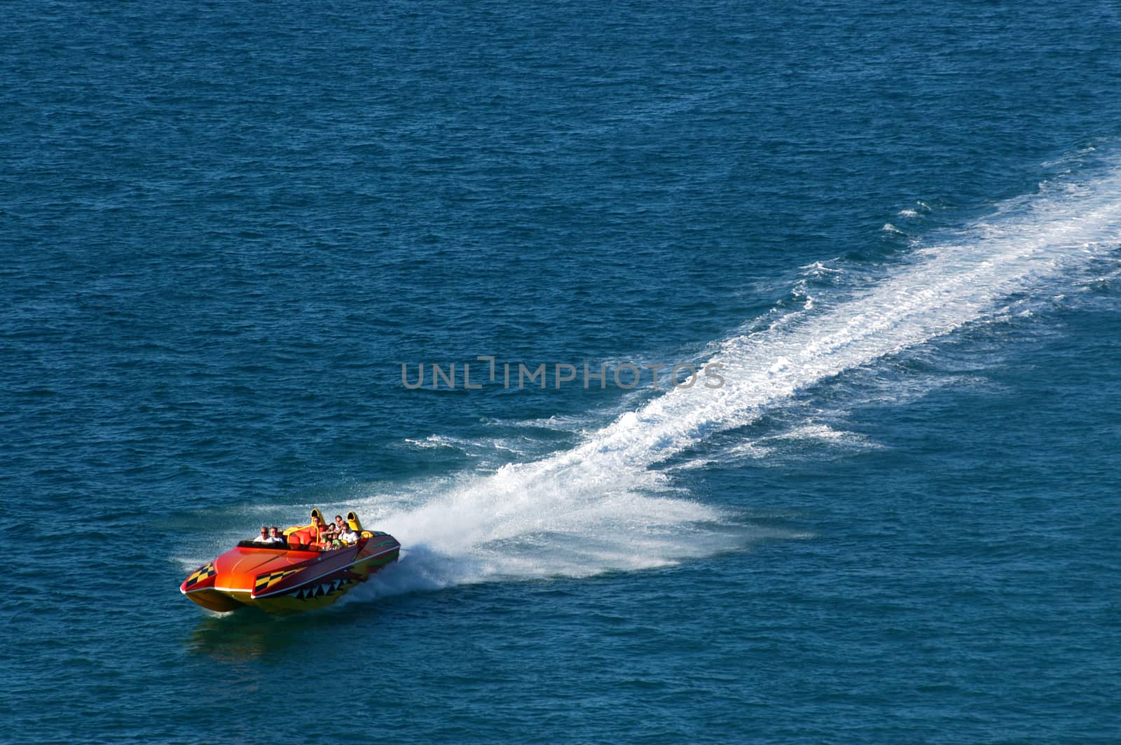 Fast boat in blue sea, aerial view