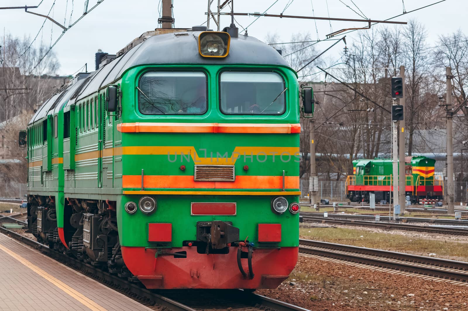 Green diesel cargo locomotive. Freight train in action