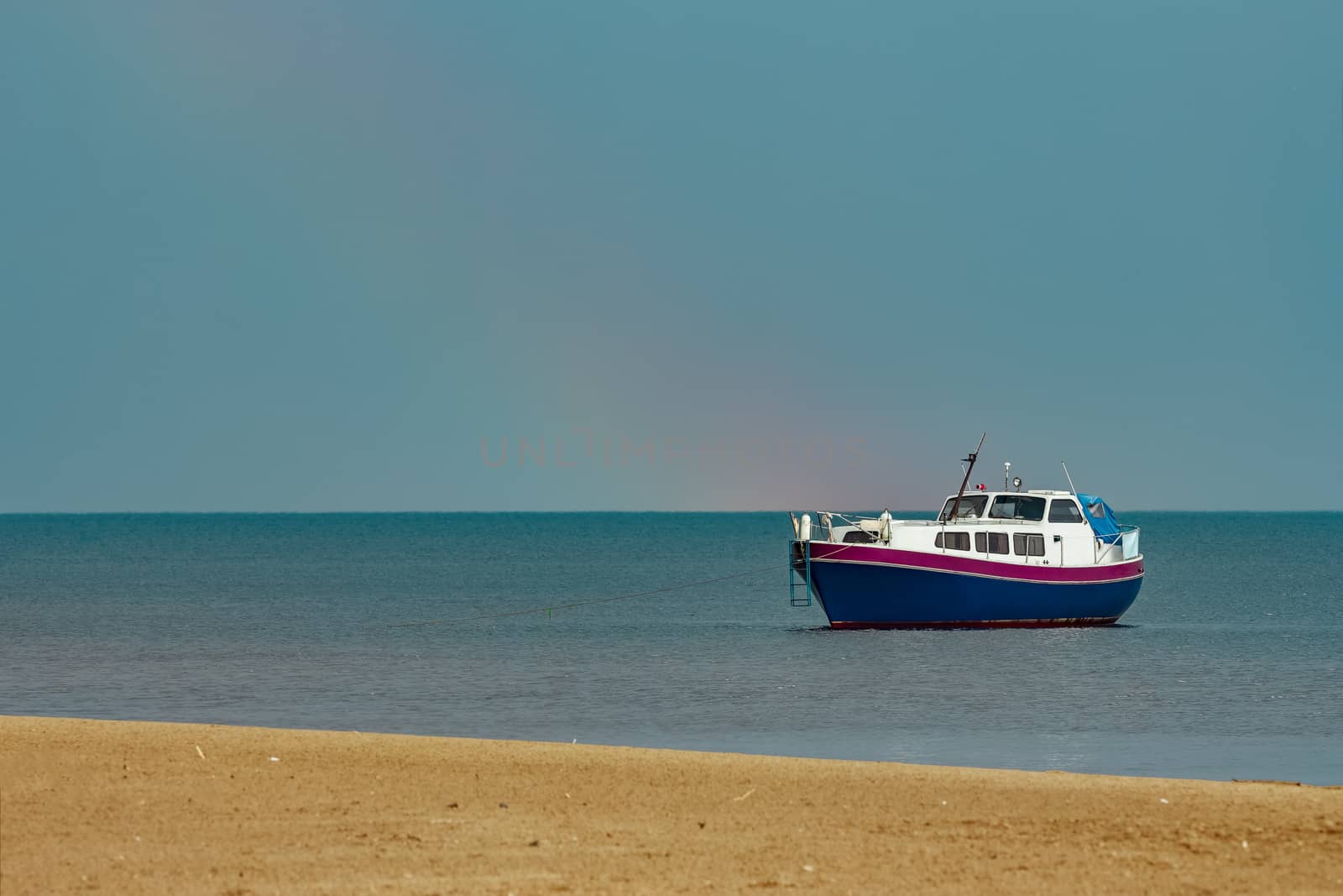 Small blue passenger ship moored at Baltic sea bay