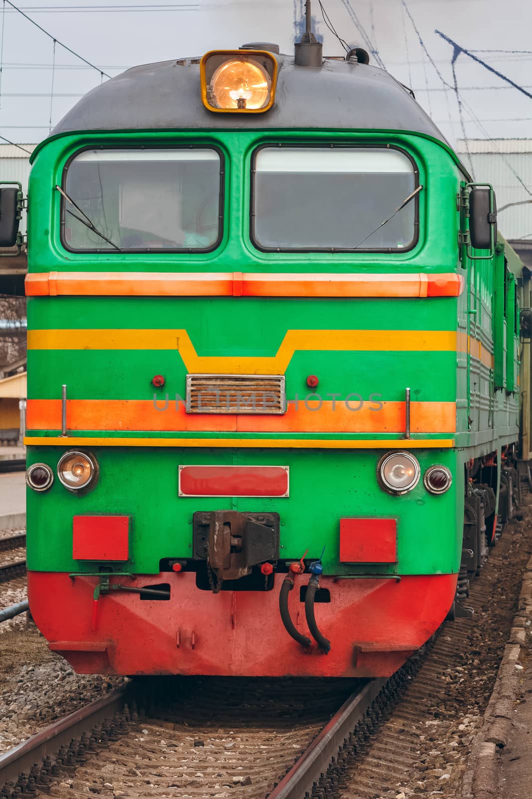 Green diesel cargo locomotive. Freight train in action