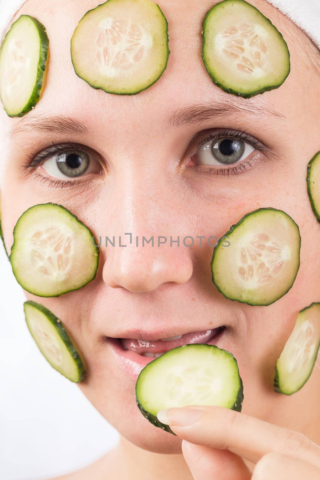 A young girl makes a face mask.