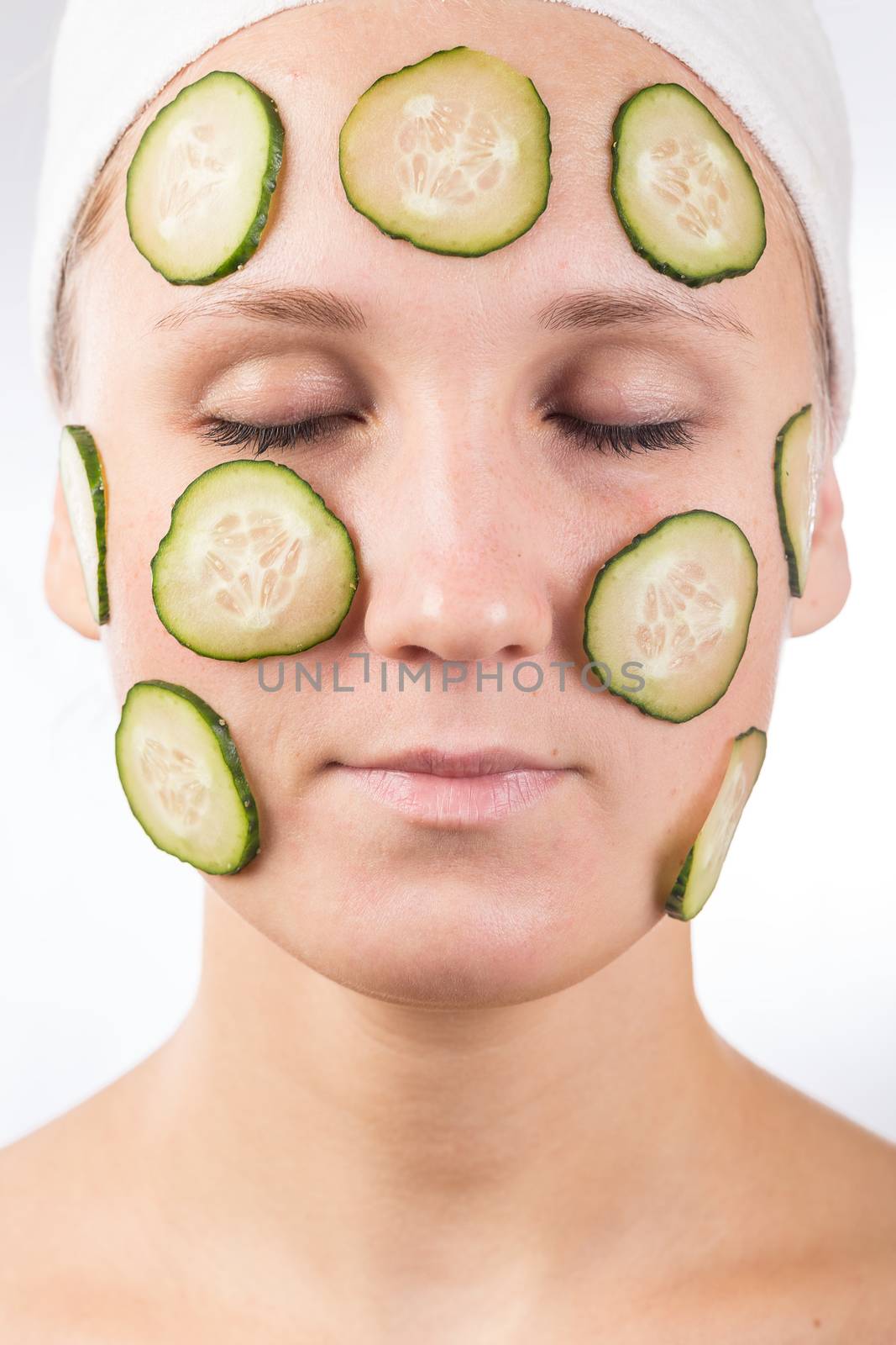 A young girl makes a face mask.