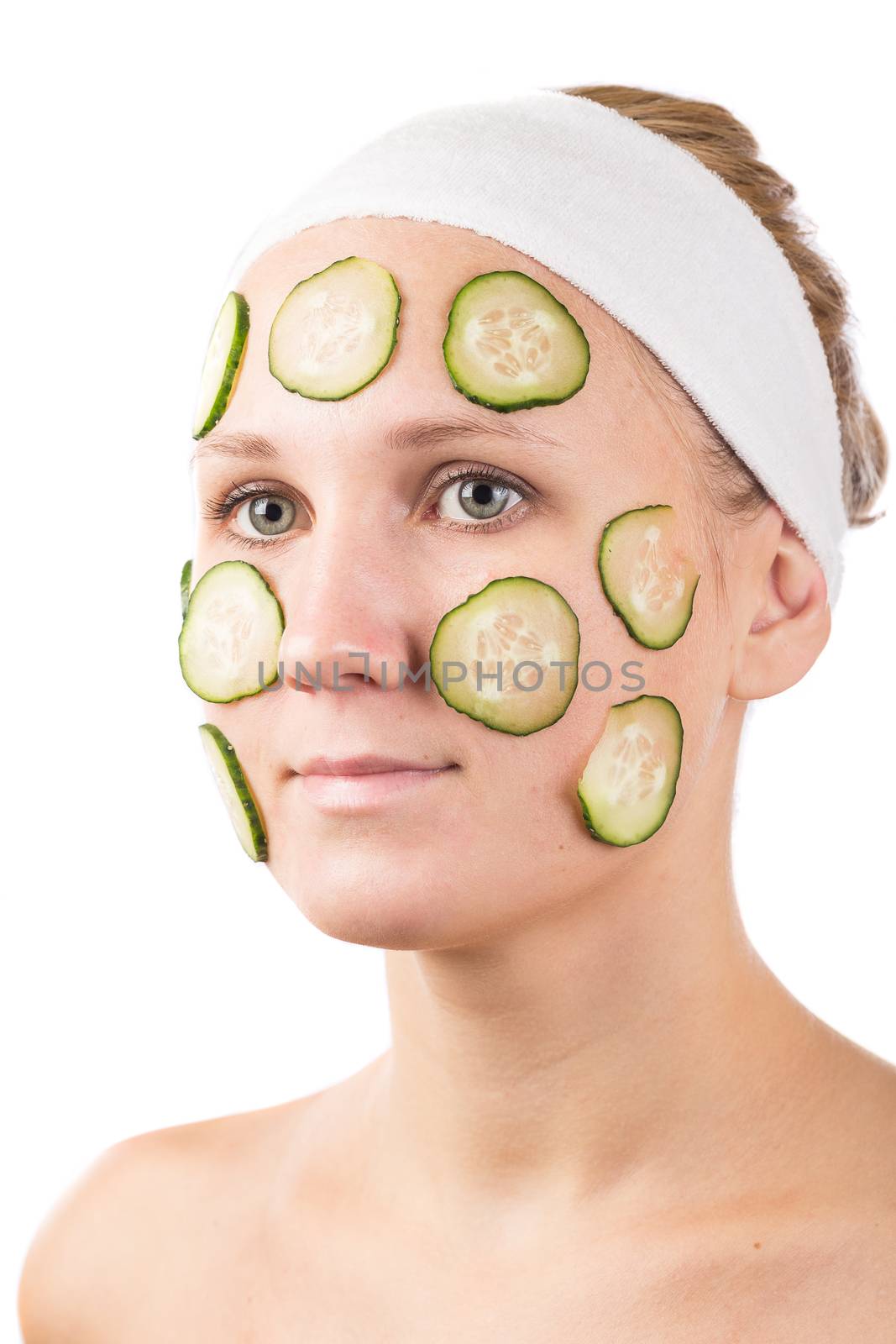 A young girl makes a face mask.