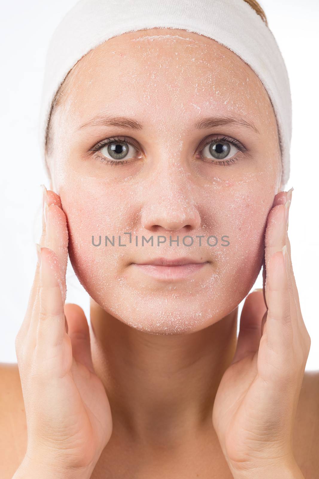 A young girl makes a face mask.